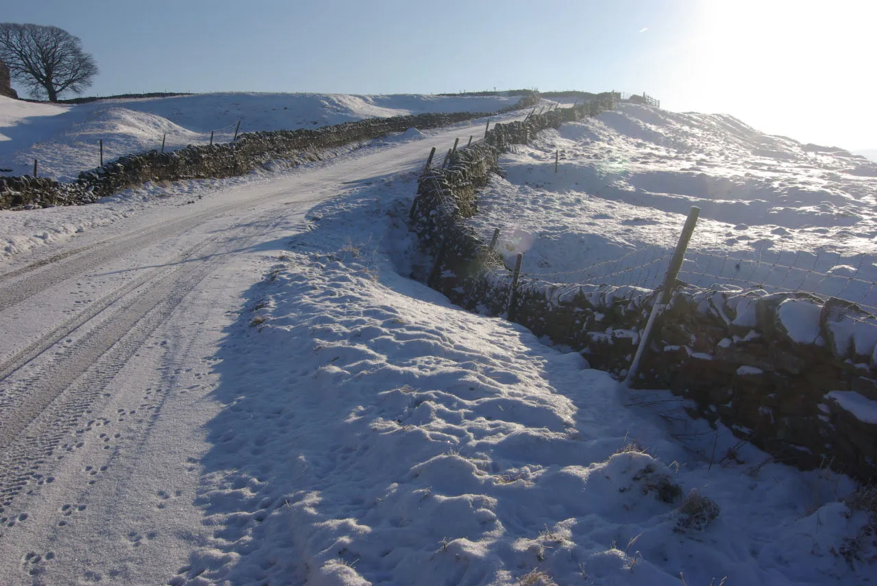 Photo showing: Road to Tan Hill, near to Barras, Cumbria, Great Britain.
Snow and an ungritted surface make this hill on the road leading eventually to the Tan Hill Inn a daunting prospect for motorists.