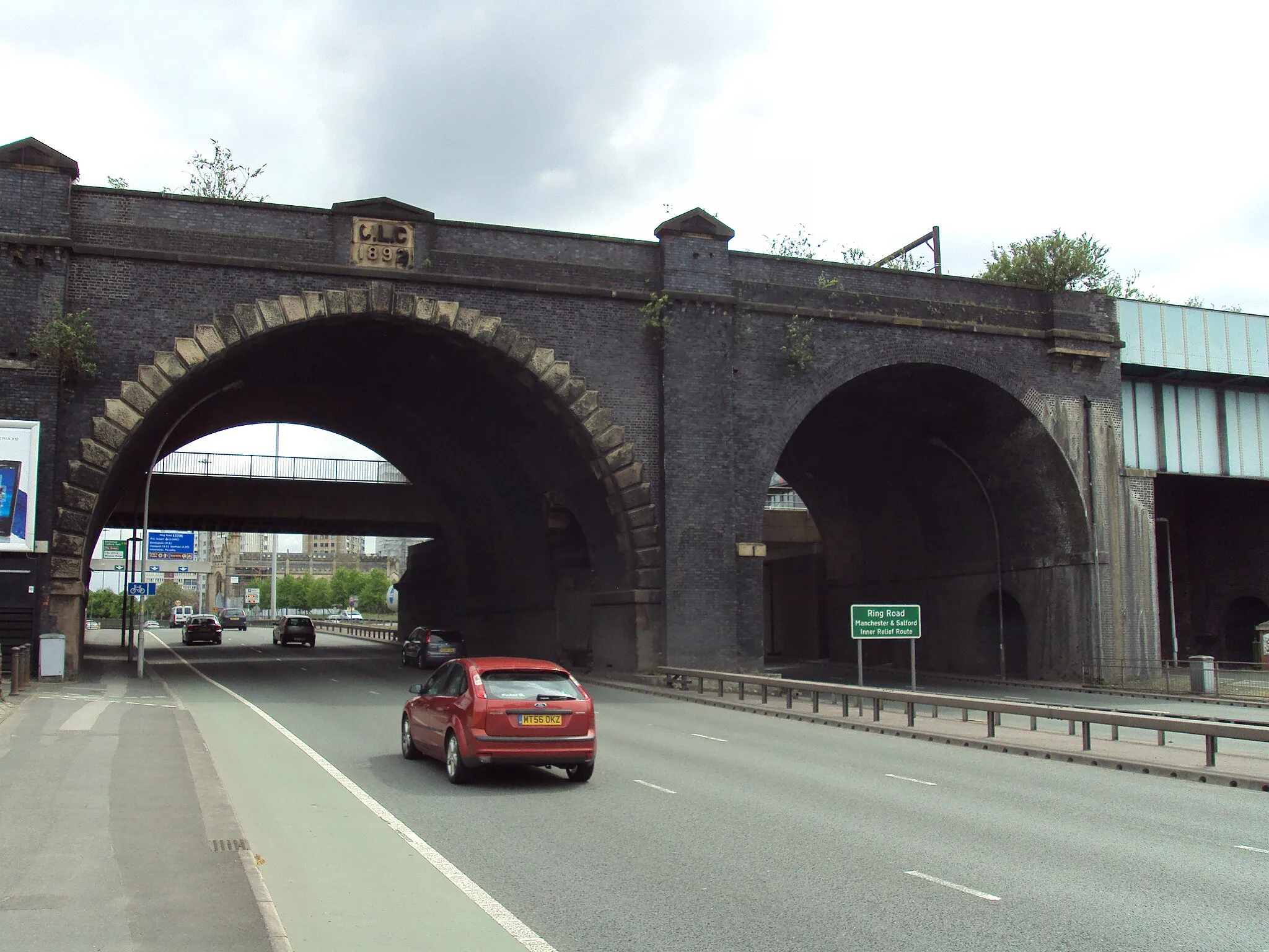 Photo showing: Railway arches now carry Metrolink trams across the A57 inner ring road at Dawson Street, Manchester