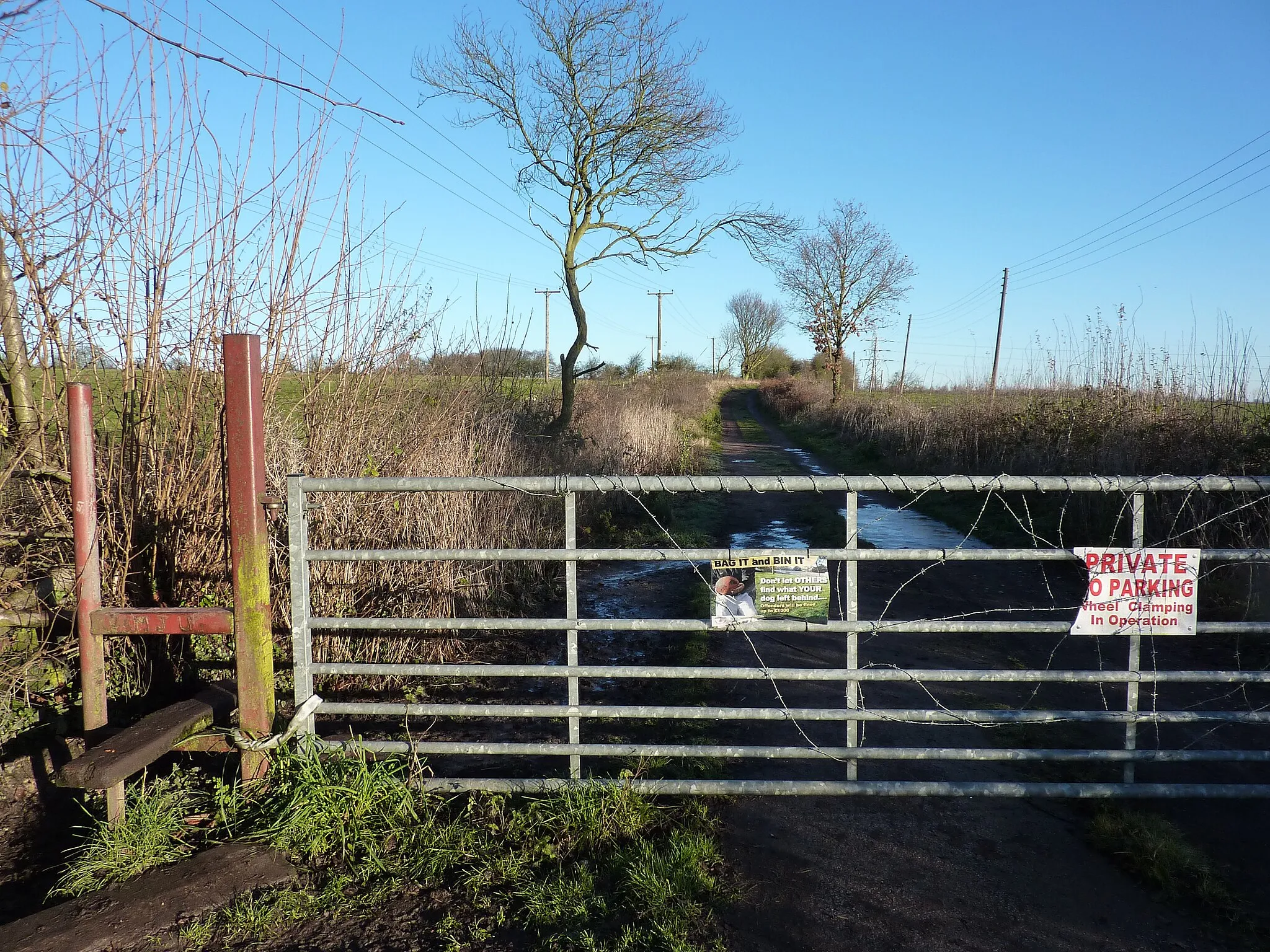 Photo showing: Barbed wired gate with signs