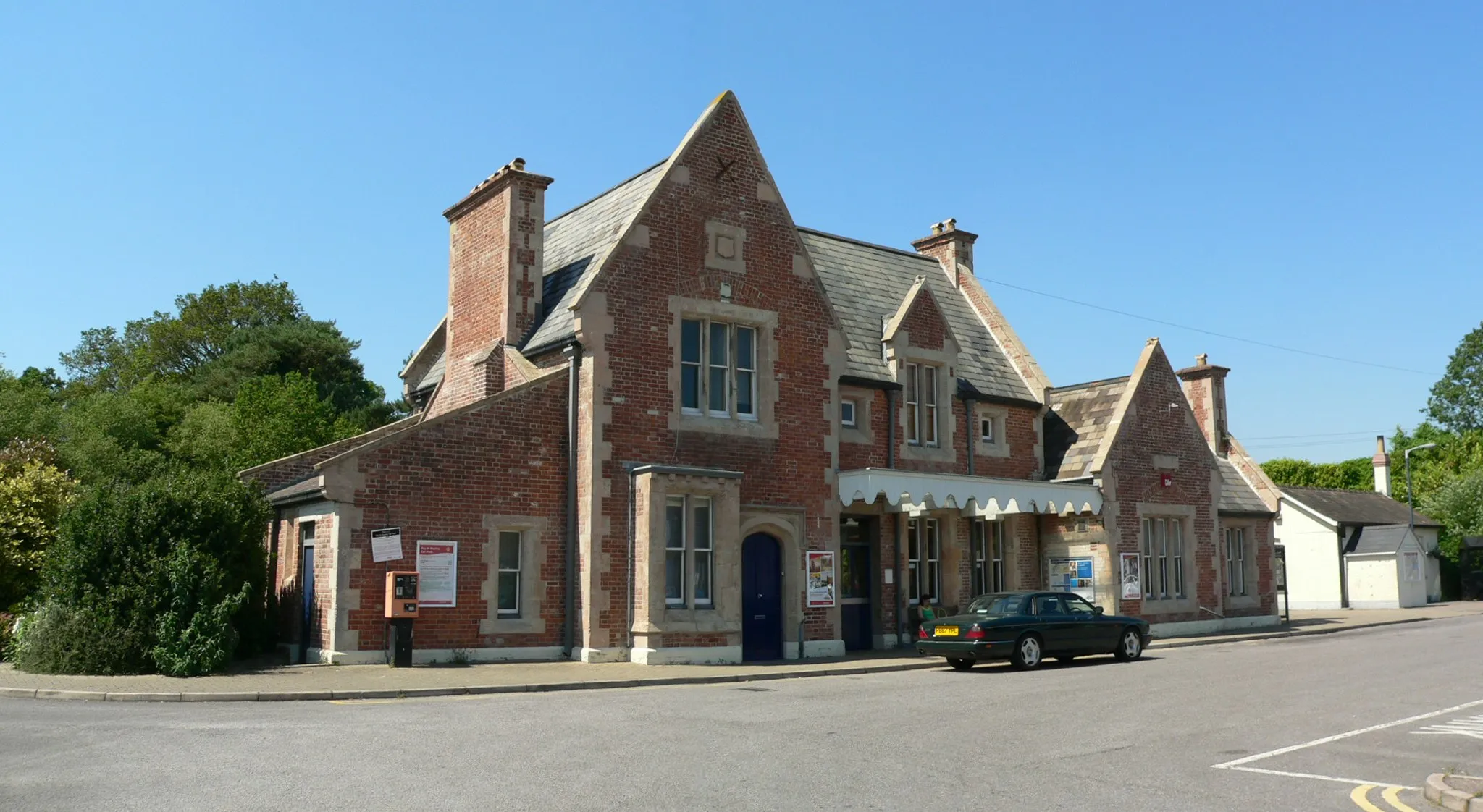 Photo showing: A merged view of the front of the station building at Axminster railway station in East Devon. Opened on 19 July 1890 the station currently only has one platform, but between 1903 and the Beeching axe of the 1960s it was the start of the branch line to Lyme Regis.