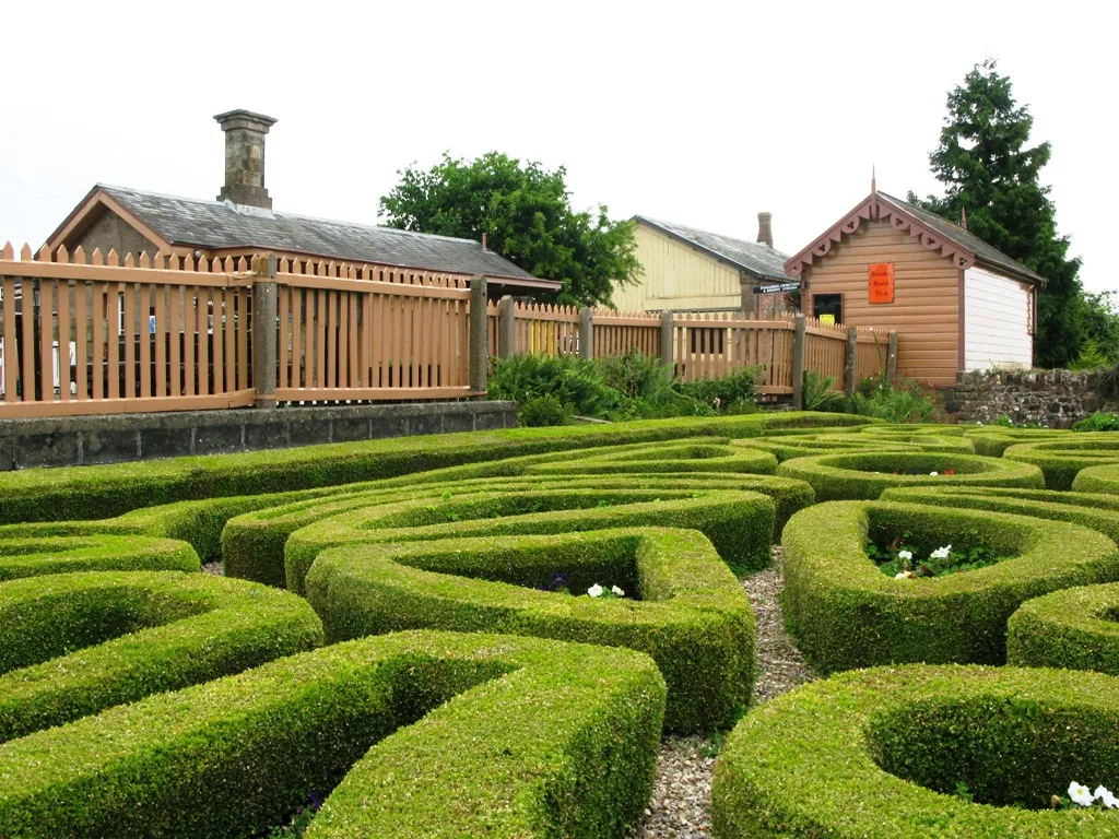Photo showing: The topiary garden at the Highbridge Nursery in Williton, Somerset, England. This long-standing feature has been admired by many visitors passsing through the railway station next door.