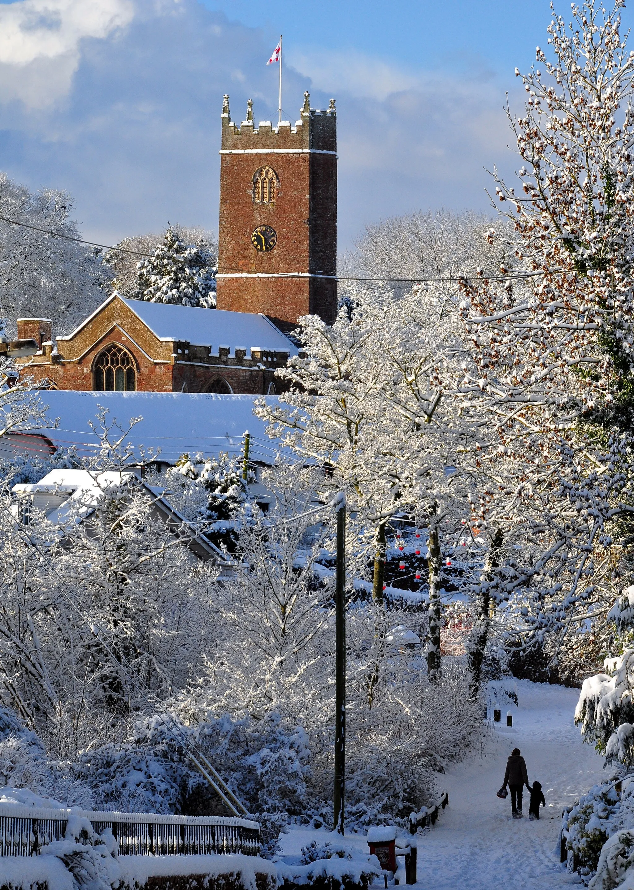 Photo showing: View southwest across part of Halberton, Devon, in snow, to St Andrew's parish church