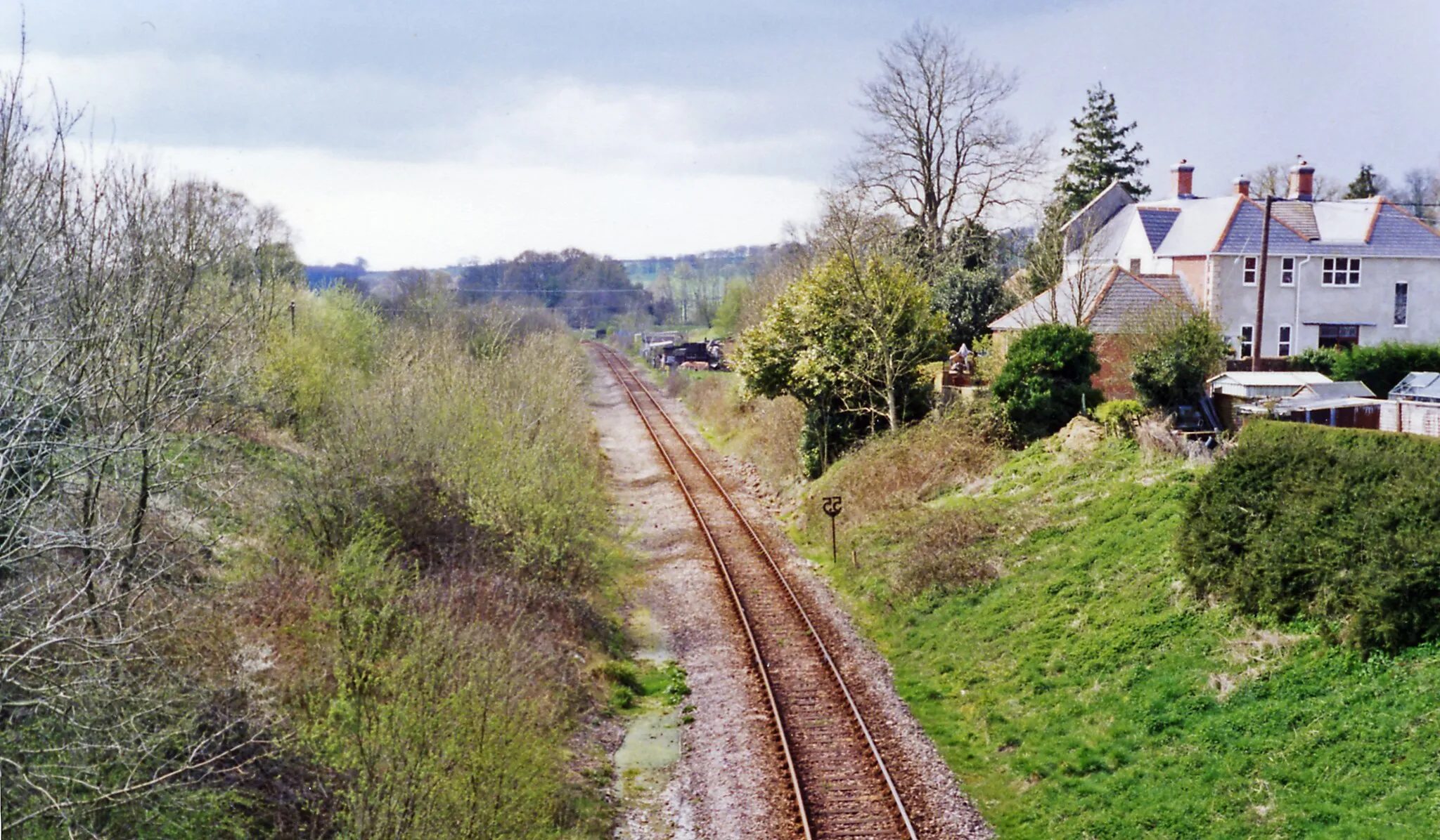 Photo showing: Site of Evershot station, 1995.
View southward, towards Dorchester and Weymouth: ex-GWR (London, Bristol etc.) - Westbury - Yeovil - Dorchester - Weymouth main line. The station was closed 3/10/66 and the line singled about that time. This was the summit of a stiff climb in both directions.