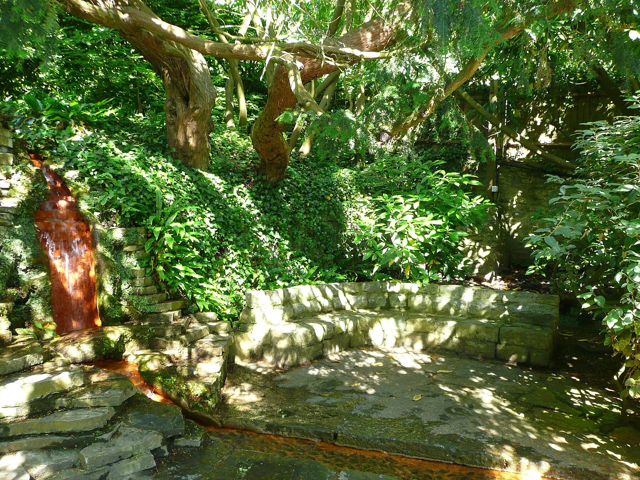 Photo showing: Waterfall and seating area next to the Healing Pool.