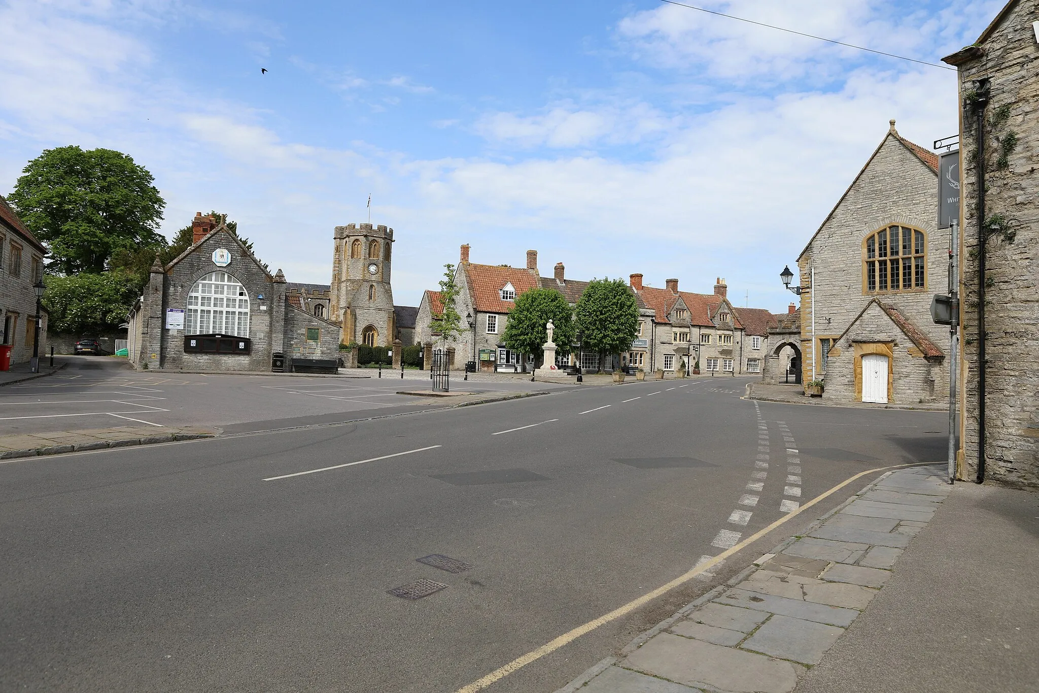 Photo showing: Somerton Town Centre with houses and a pub on the right and trees on the left.