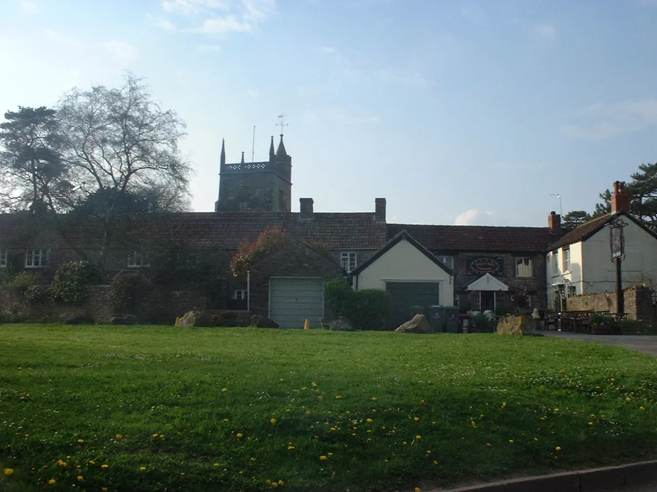 Photo showing: The Pub and Church tower in Hinton Blewitt. Taken by Rod Ward 24th April 2006