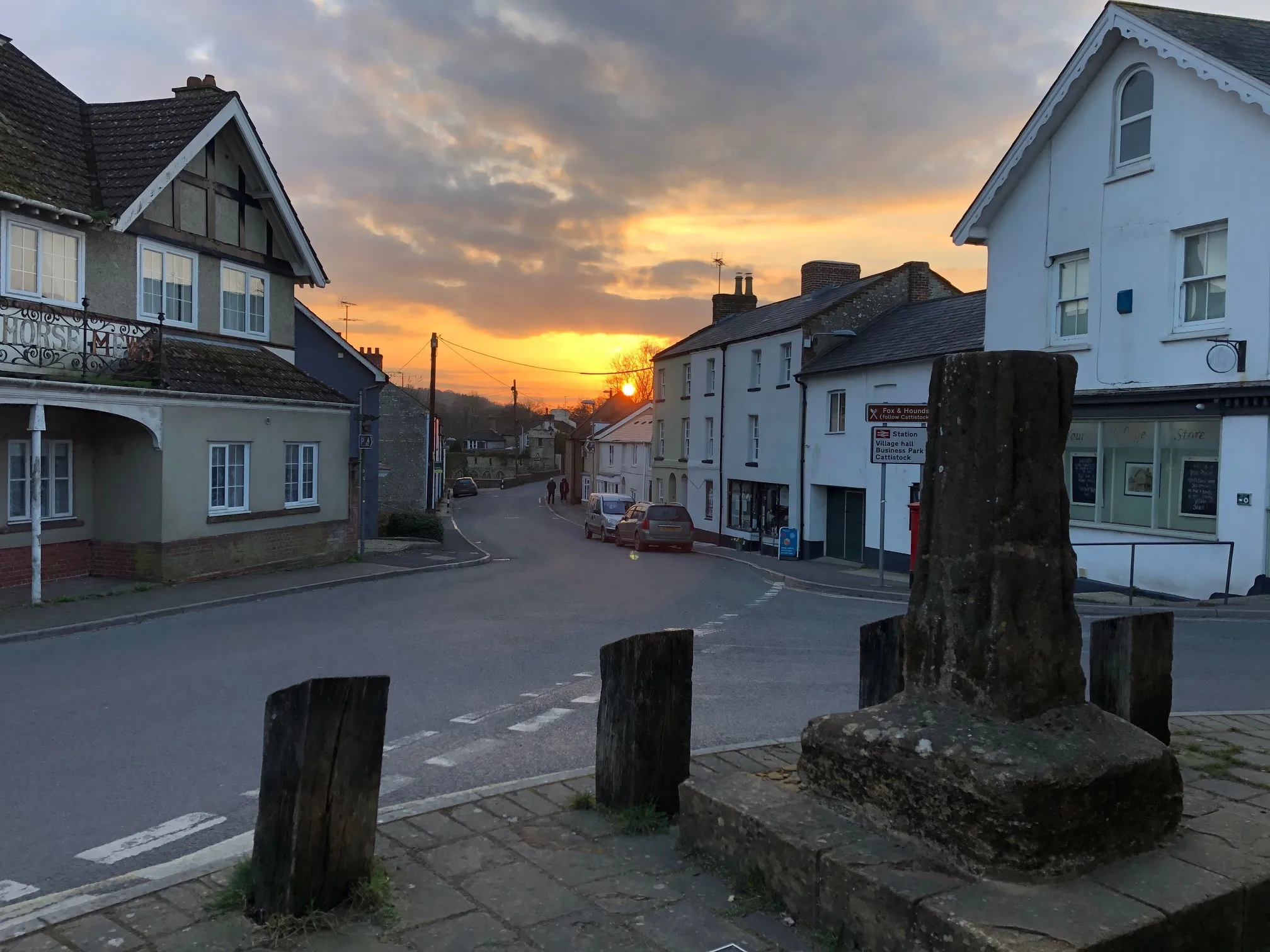 Photo showing: Sunset in the centre of the village with 15C Village Cross in the foreground.