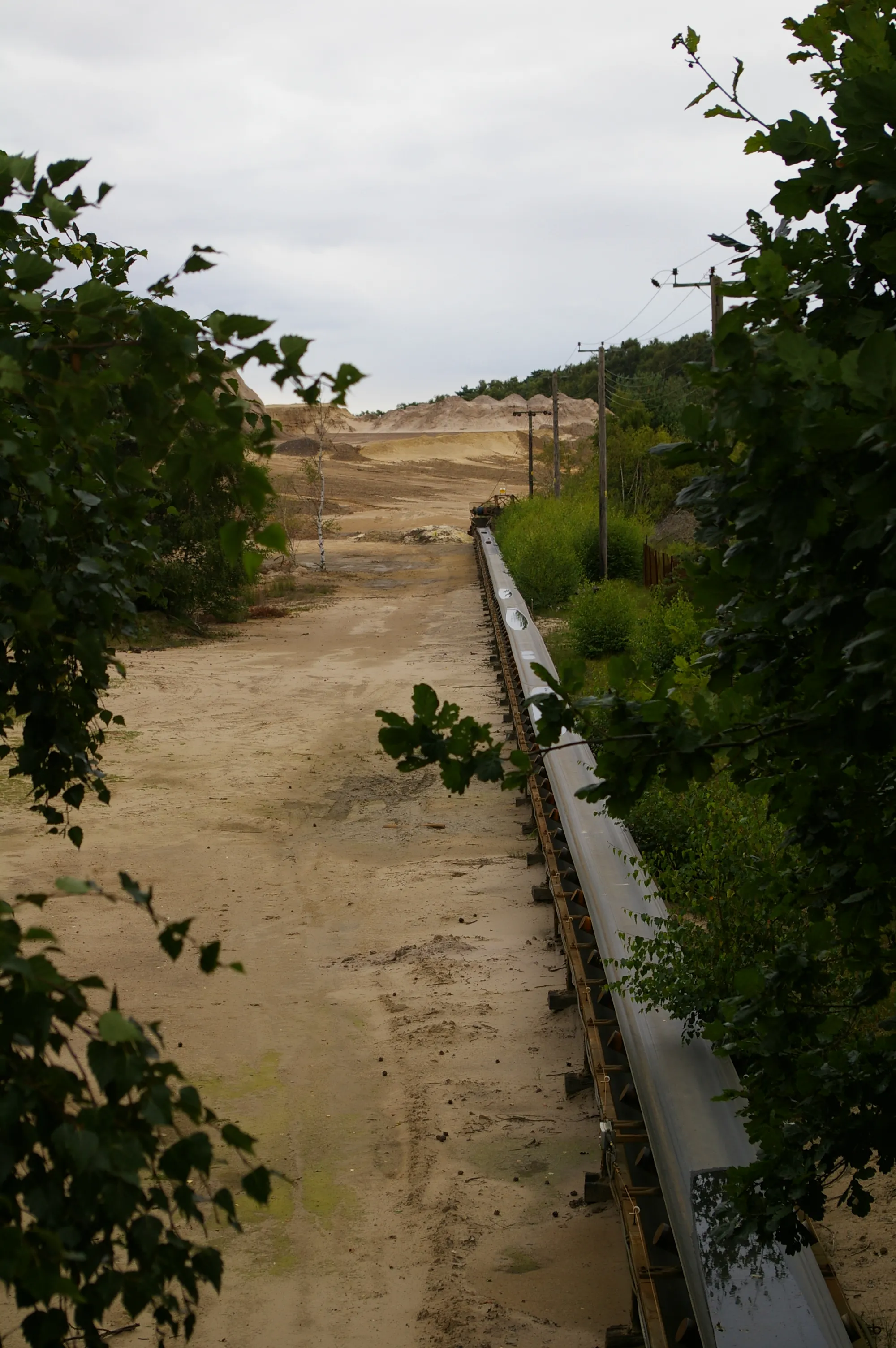 Photo showing: Sand conveyor, King's Lynn quarry The conveyor crosses under the road, from the sand pits on one side to the processing plants on the other.