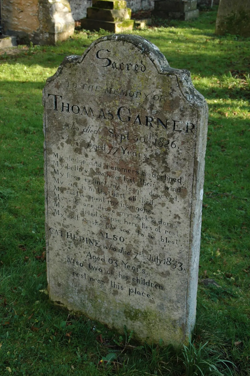 Photo showing: A gravestone for a village blacksmith with a suitably poetic epitaph. Located in the churchyard of St Mary's, Houghton, Cambridgeshire