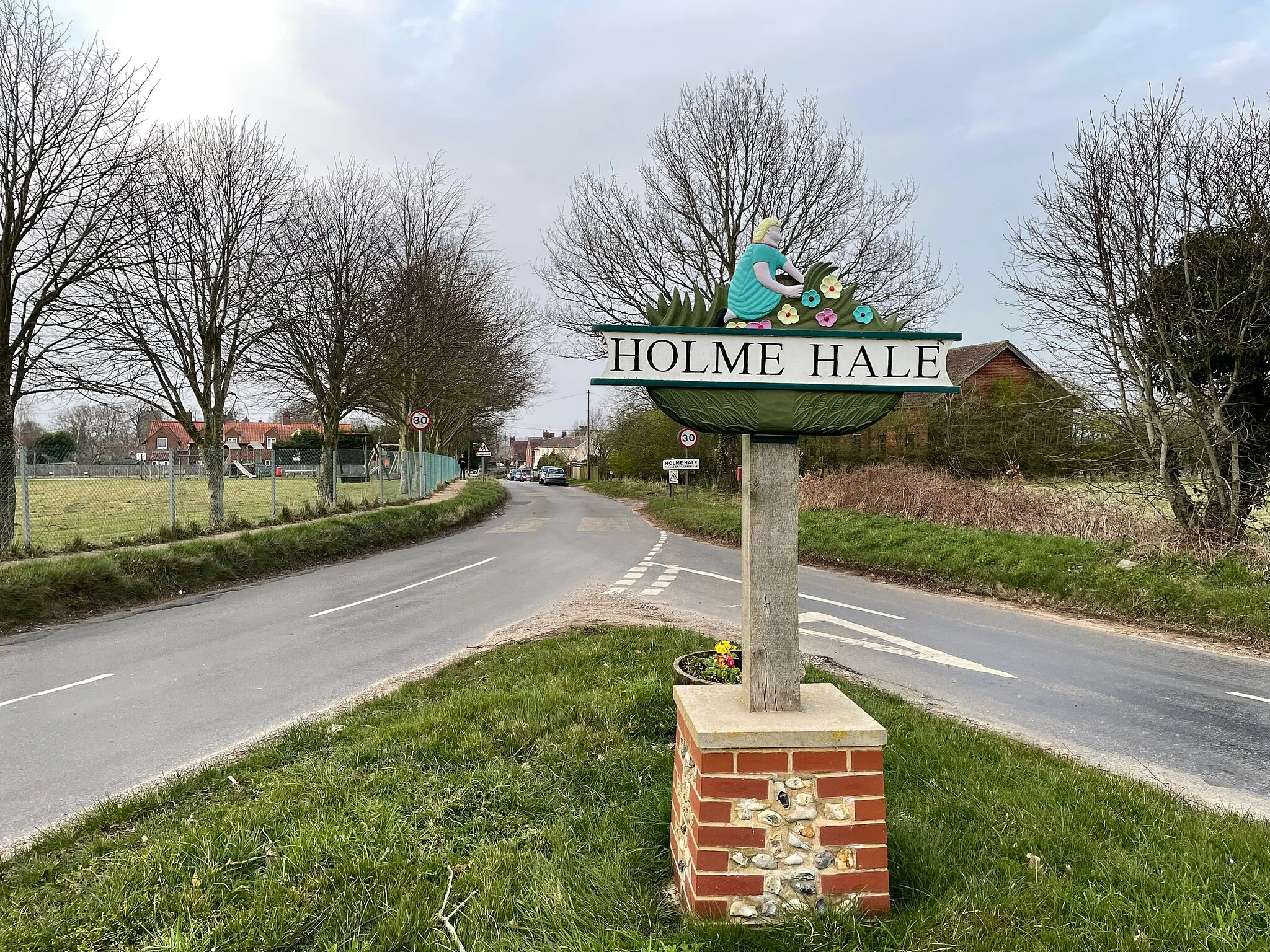 Photo showing: The sign at one of the entrances to the boundary of Holme Hale village, Norfolk, possibly demonstrating its participation in the british gardens scheme