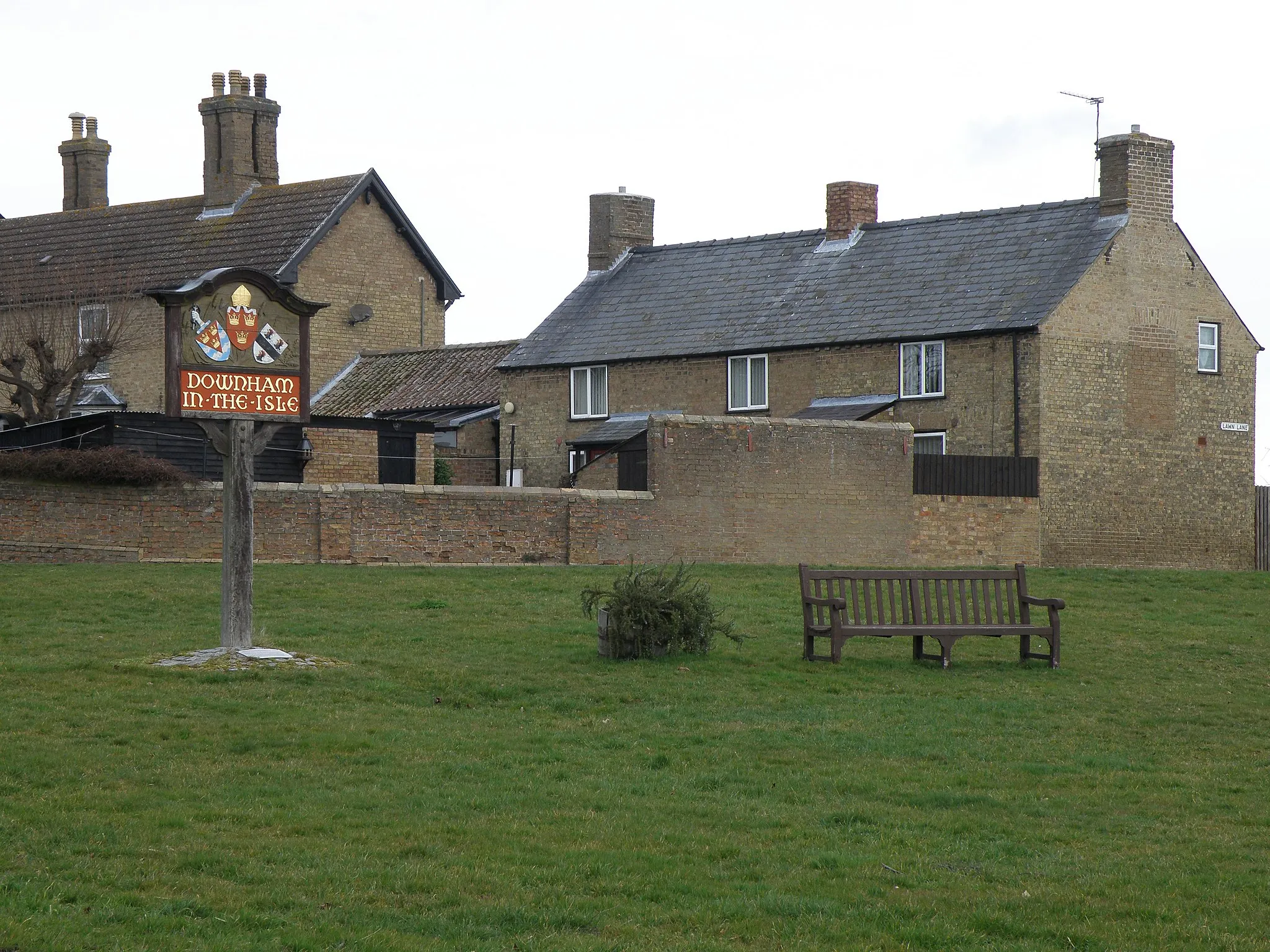 Photo showing: Village sign in Little Downham. Using the historical name of Downham in the Isle the village sign is located on the green at a busy road junction.