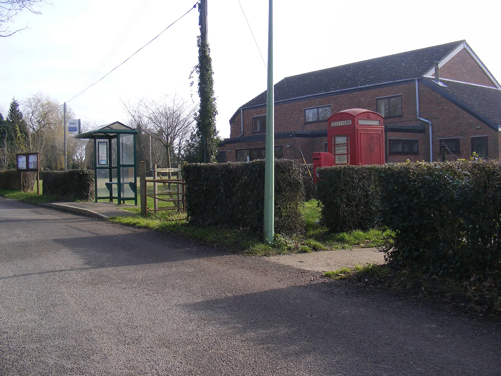 Photo showing: Bus Shelter,Telephone Box & St.James Postbox & St James Village Hall