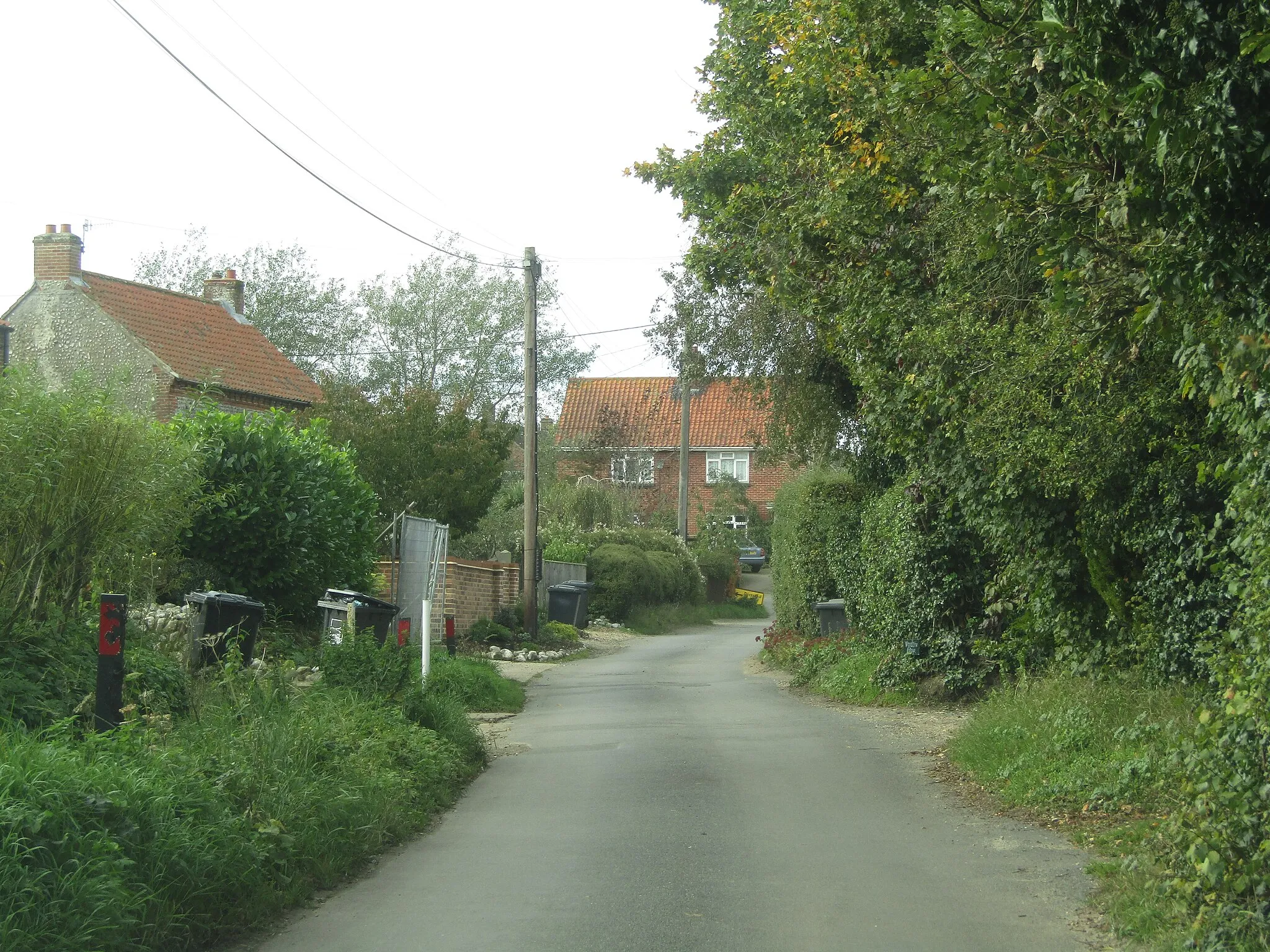 Photo showing: Looking west along ΄The Street΄ in the village of Aylmerton, Norfolk, England.
