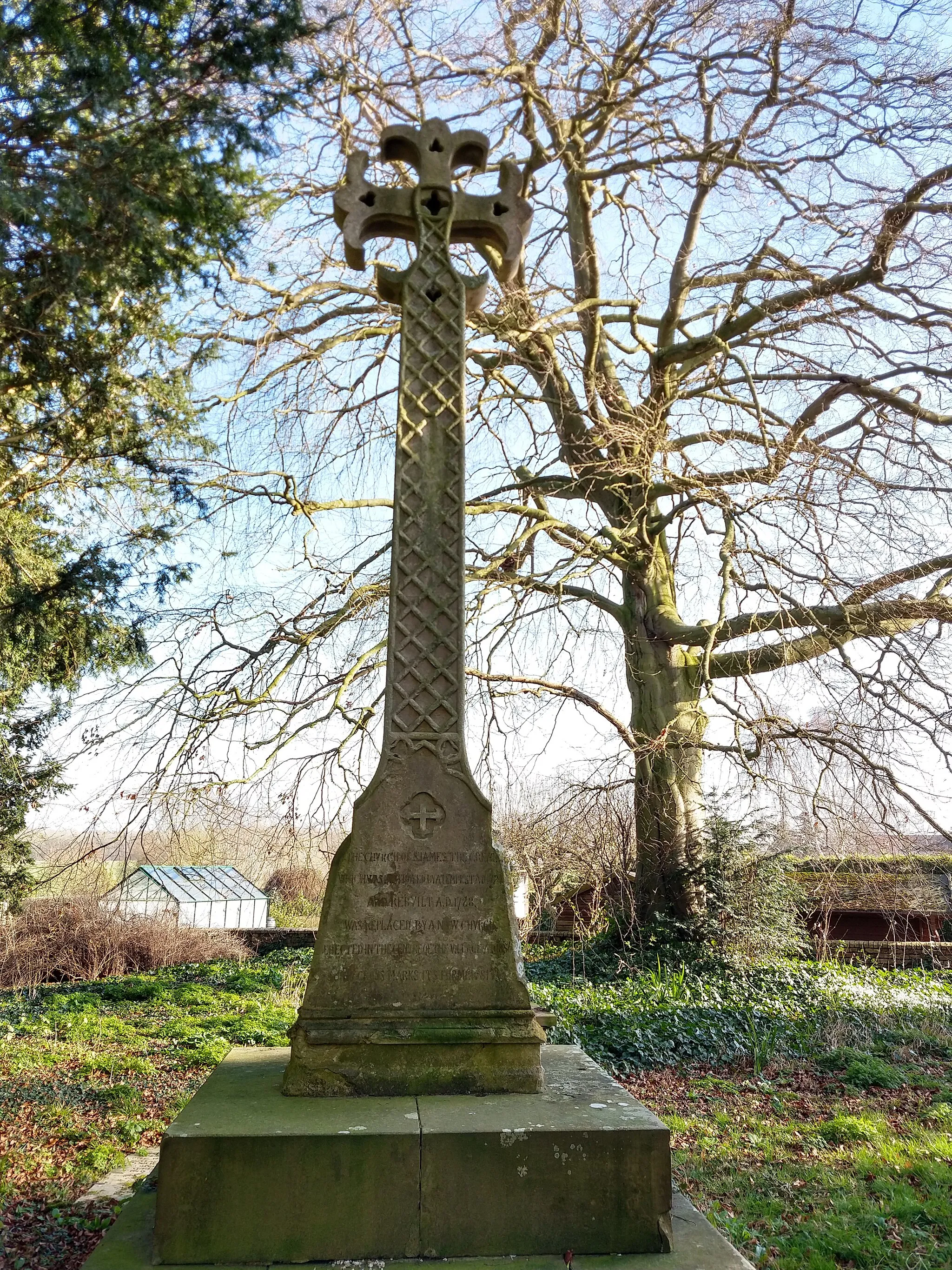 Photo showing: cross showing the location of the former Church of St James, in the Old Churchyard, Vicarage Road, Waresley, Huntingdonshire. Inscription reads "The Church of St James the Great, which was destroyed by a tempest AD 1724 and rebuilt AD 1728 was replaced by a new church erected in the centre of the village AD 1856. This cross marks its former site."