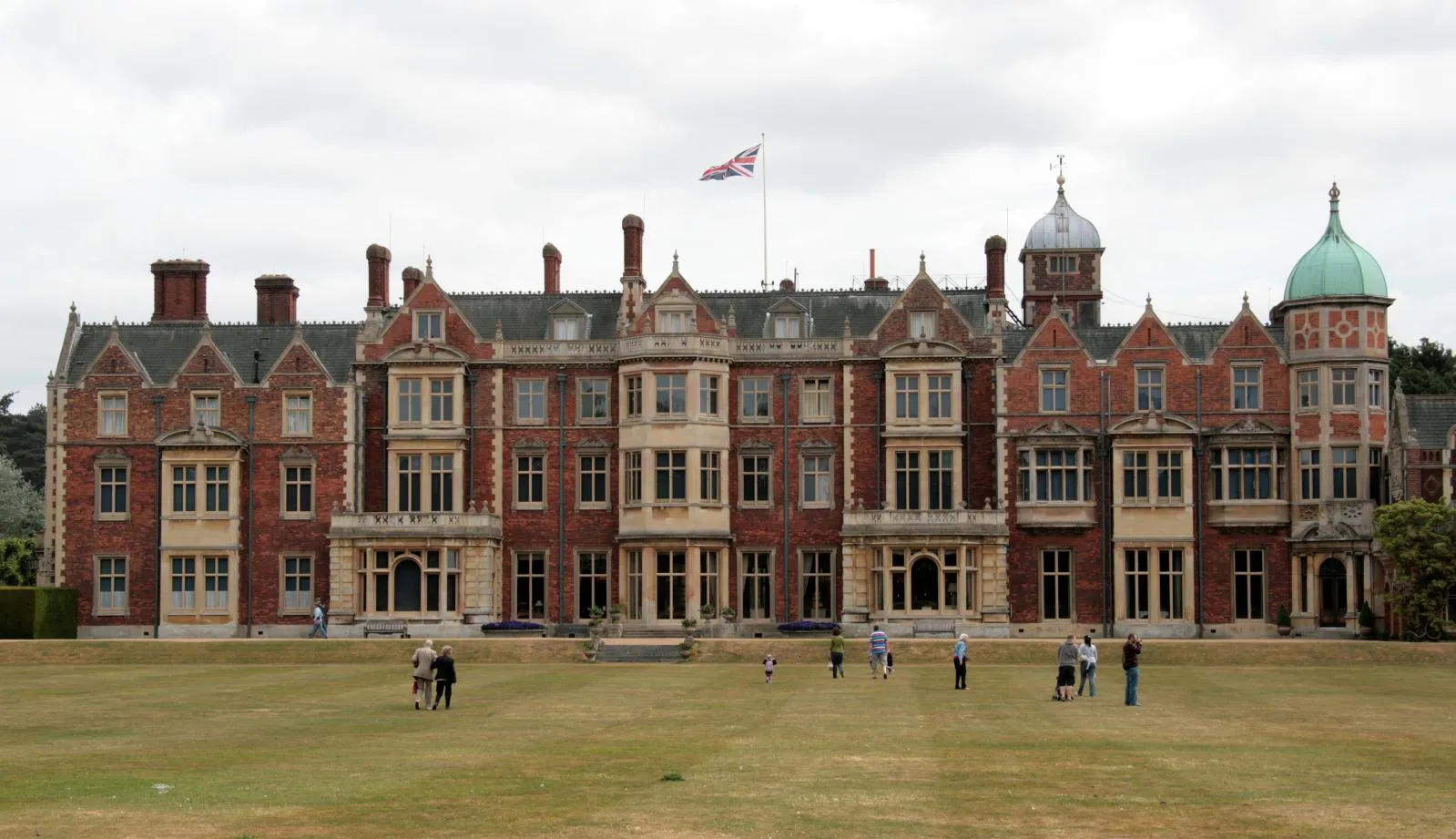 Photo showing: The Norfolk retreat of HM The Queen.
Sandringham is the much-loved country retreat of Her Majesty The Queen, and has been the private home of four generations of British monarchs since 1862. The house, set in 24 hectares of stunning gardens, is perhaps the most famous stately home in Norfolk and is at the heart of the 8,000-hectare Sandringham Estate, 240 hectares of which make up the woodland and heath of the Country Park.

The Museum at Sandringham holds an extraordinary collection ranging from the very large - the 1939 Merryweather fire engine - to the very small - tiny Indian doll dancers in the Curio Cupboard - and from the grand - gifts in pearl and exotic hardwoods given to The Queen on State Visits abroad - to the personal - the clock used in the Royal Pigeon Lofts at Sandringham to time Her Majesty's racing pigeons. It is housed in the former coach houses and stable block which, over the years have also been used as police post, fire brigade station, Carving School and Royal garages.