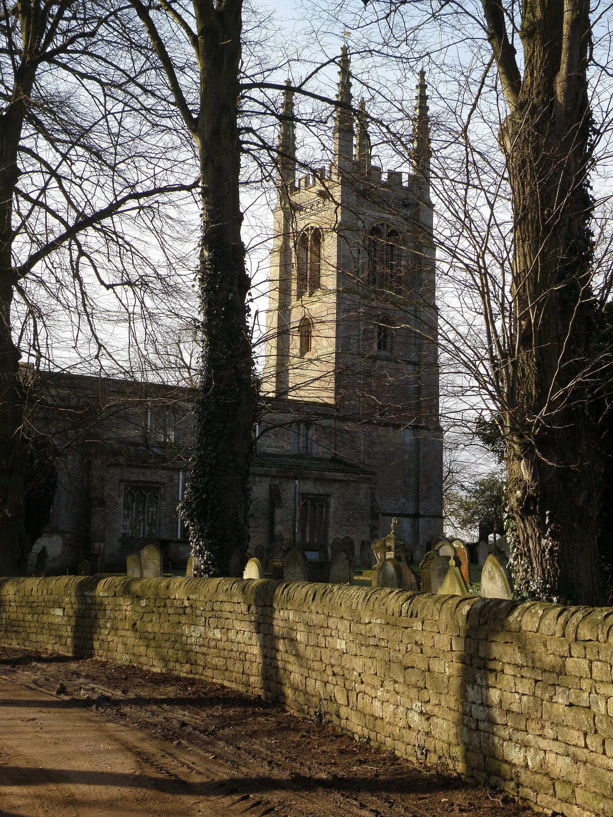 Photo showing: All Saints, Easton on the Hill An early spring view of the church unhindered by leaves on the trees.