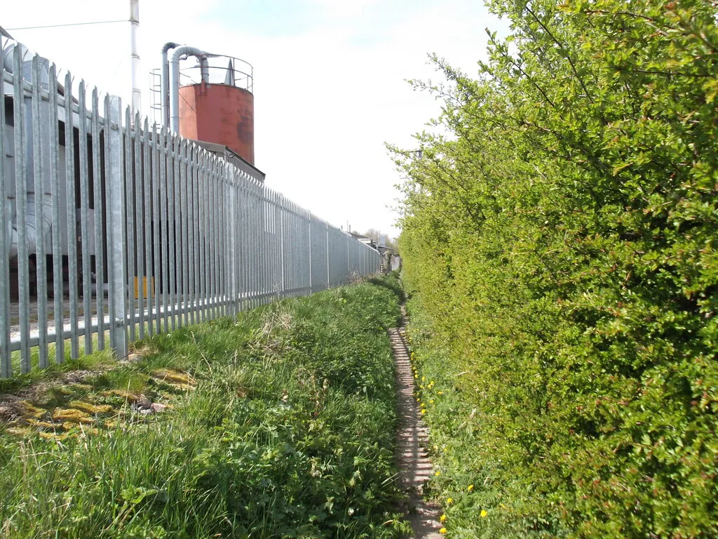 Photo showing: A narrow path beside the industrial units, Hutton Cranswick, East Riding of Yorkshire, England.