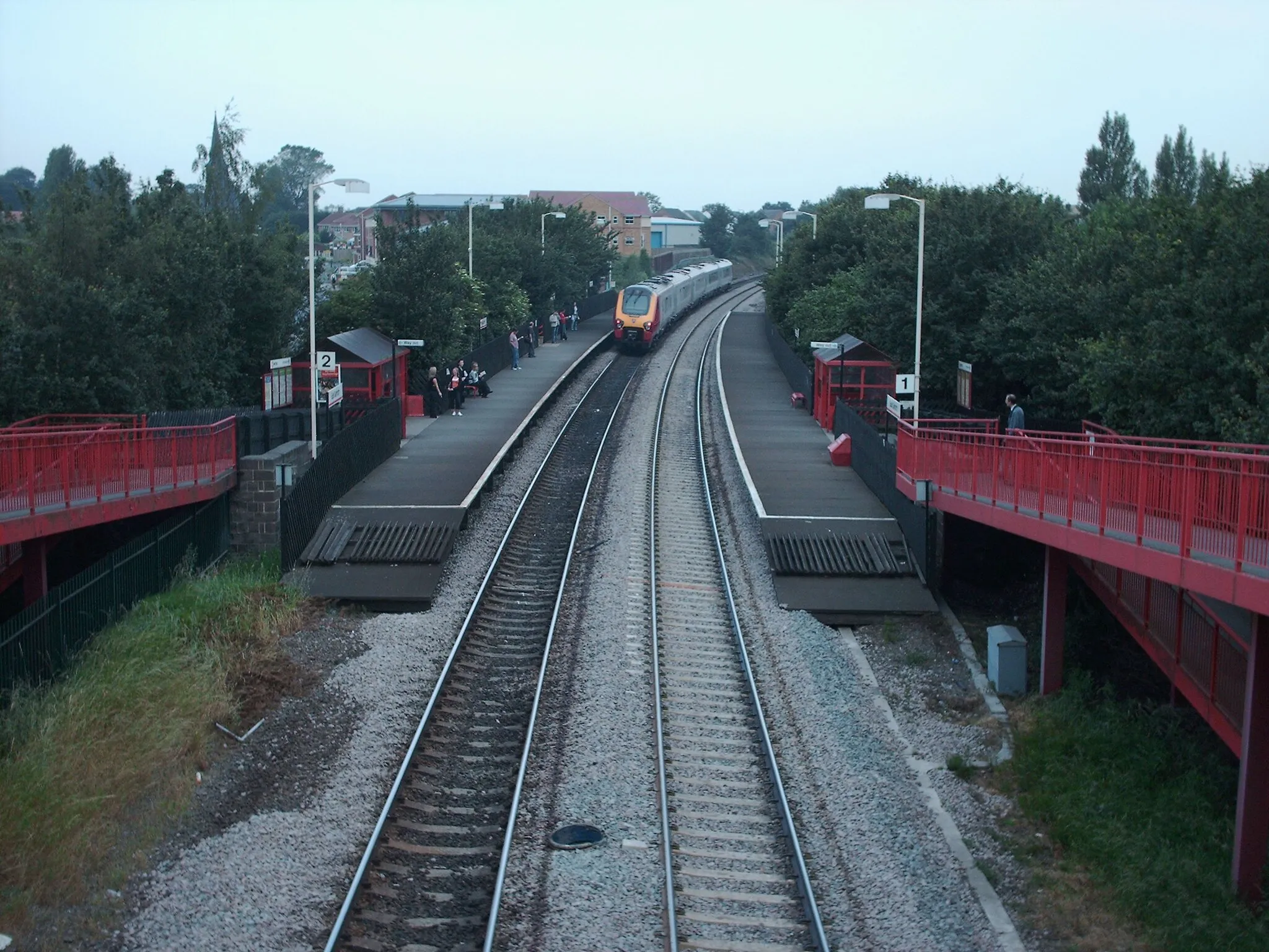 Photo showing: East Garforth train station, West Yorkshire. A Virgin Trains Voyager rushes through on its way to Leeds.
