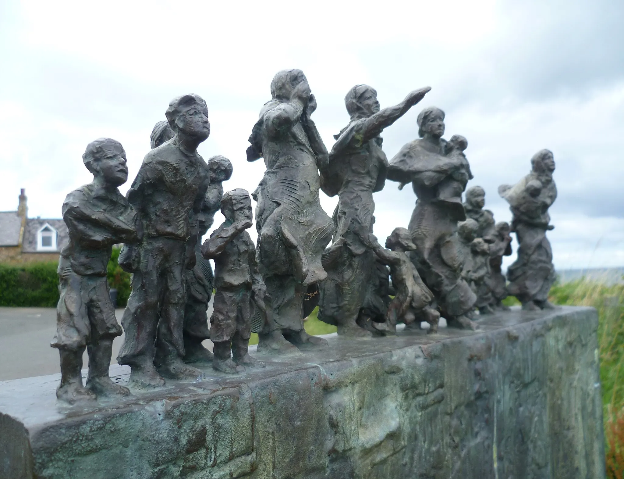 Photo showing: A moving memorial to the great loss of life in the Eyemouth disaster of 1881, created by Jill Watson sculptor.
Wha'll buy my caller herrin'?*
They're no' brought here without brave darin',
Buy my caller herrin',
Haul'd through wind and rain. Buy my caller herrin'!
Though ye may ca' them vulgar farin'.
Wives and mithers, maist despairin',
Ca' them lives o' men.
(Lady Nairne)
*fresh herring