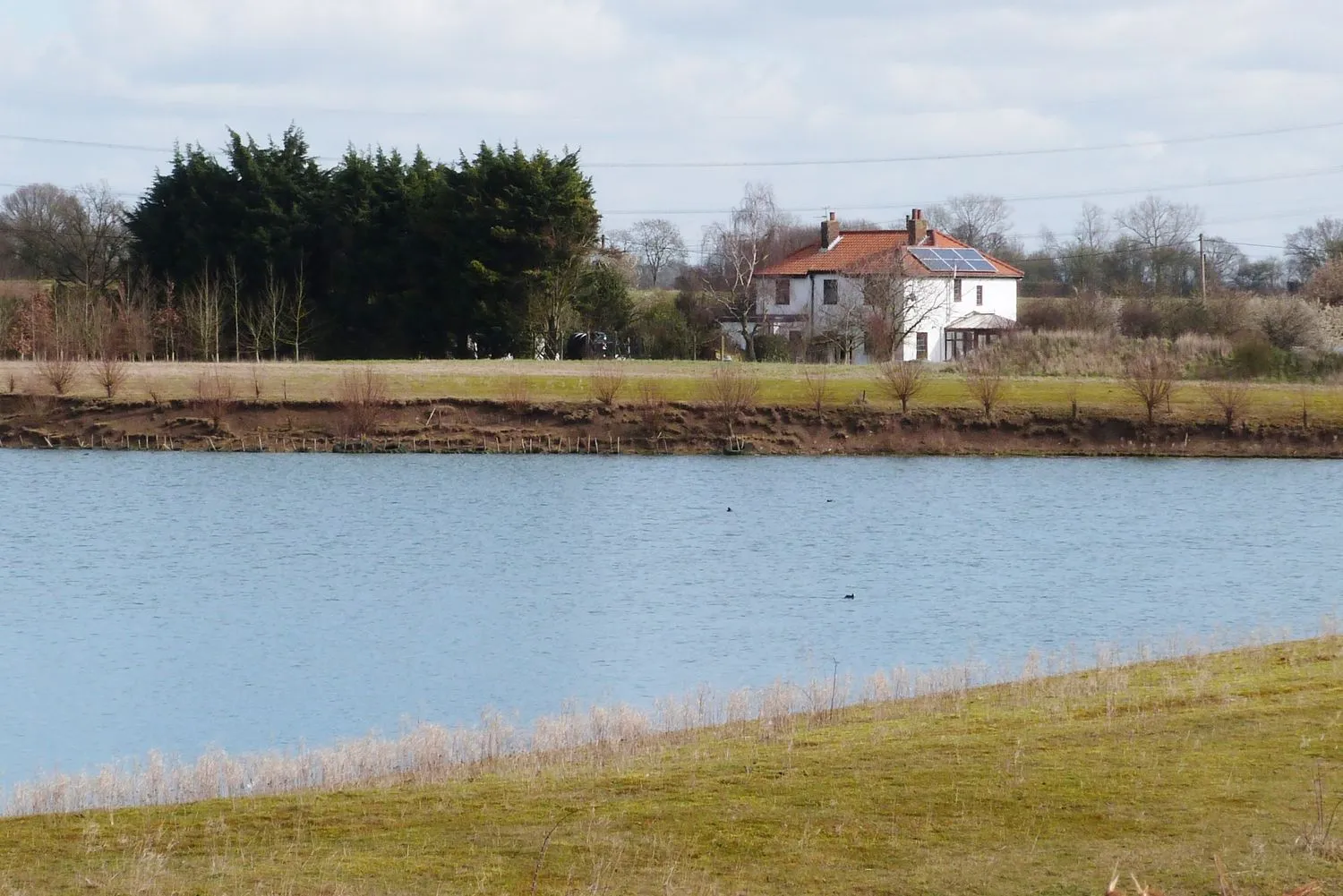 Photo showing: Russell Green House from across the flooded gravel pit