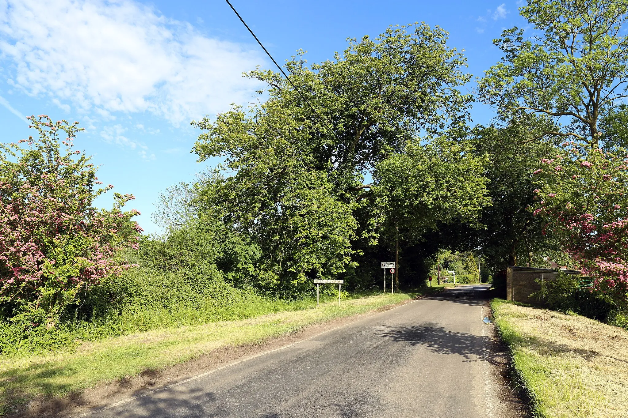 Photo showing: Road from the north-west into the hamlet of Hellmans Cross in the civil parish of Great Canfield, in Essex, England. The hamlet gets its name from 'Helmans', a late 16th-century Grade II listed house 240 yards south-east from the centre of the hamlet.