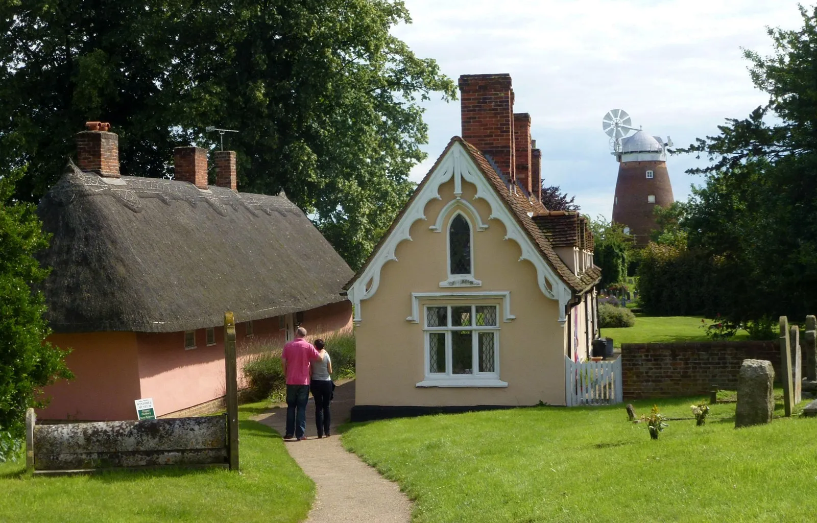Photo showing: Almshouses at the parish church of St John in Thaxted, with the sailless John Webb's Windmill in the background, in July 2012.