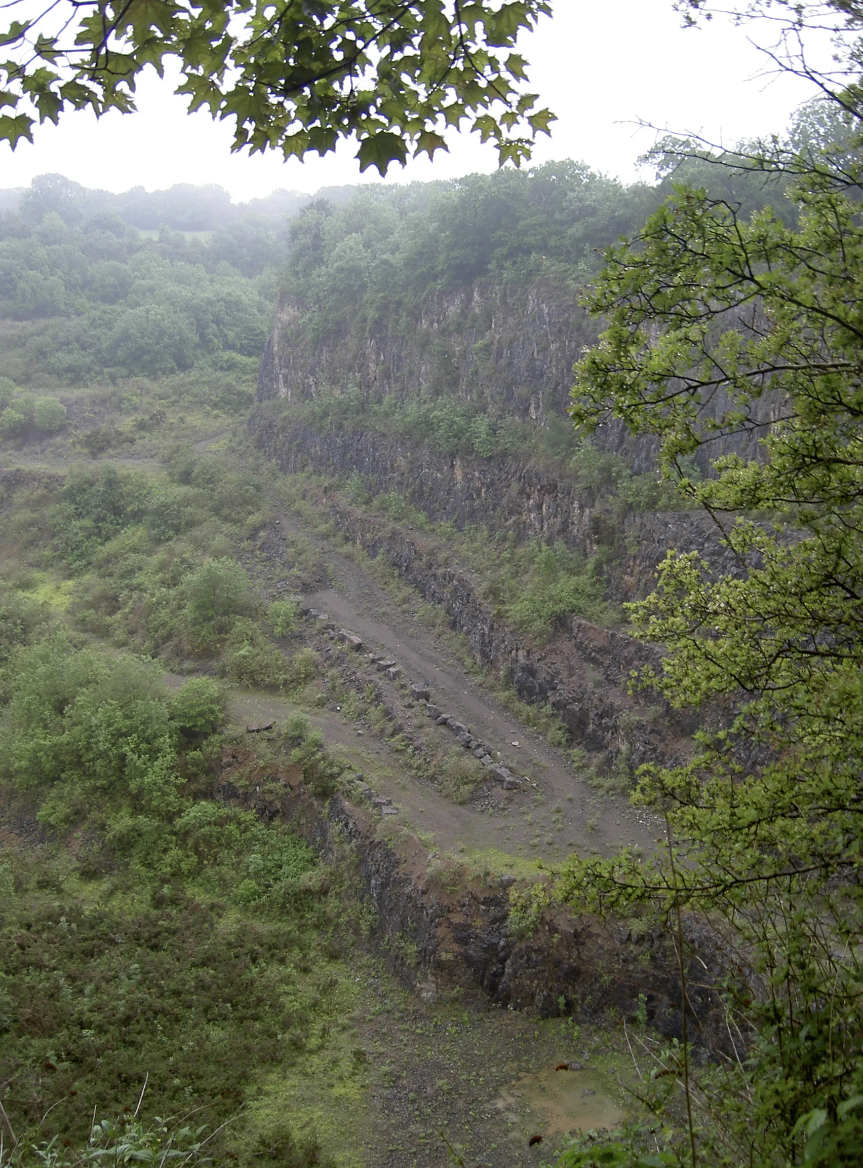 Photo showing: A road at the bottom of the quarry cliffs