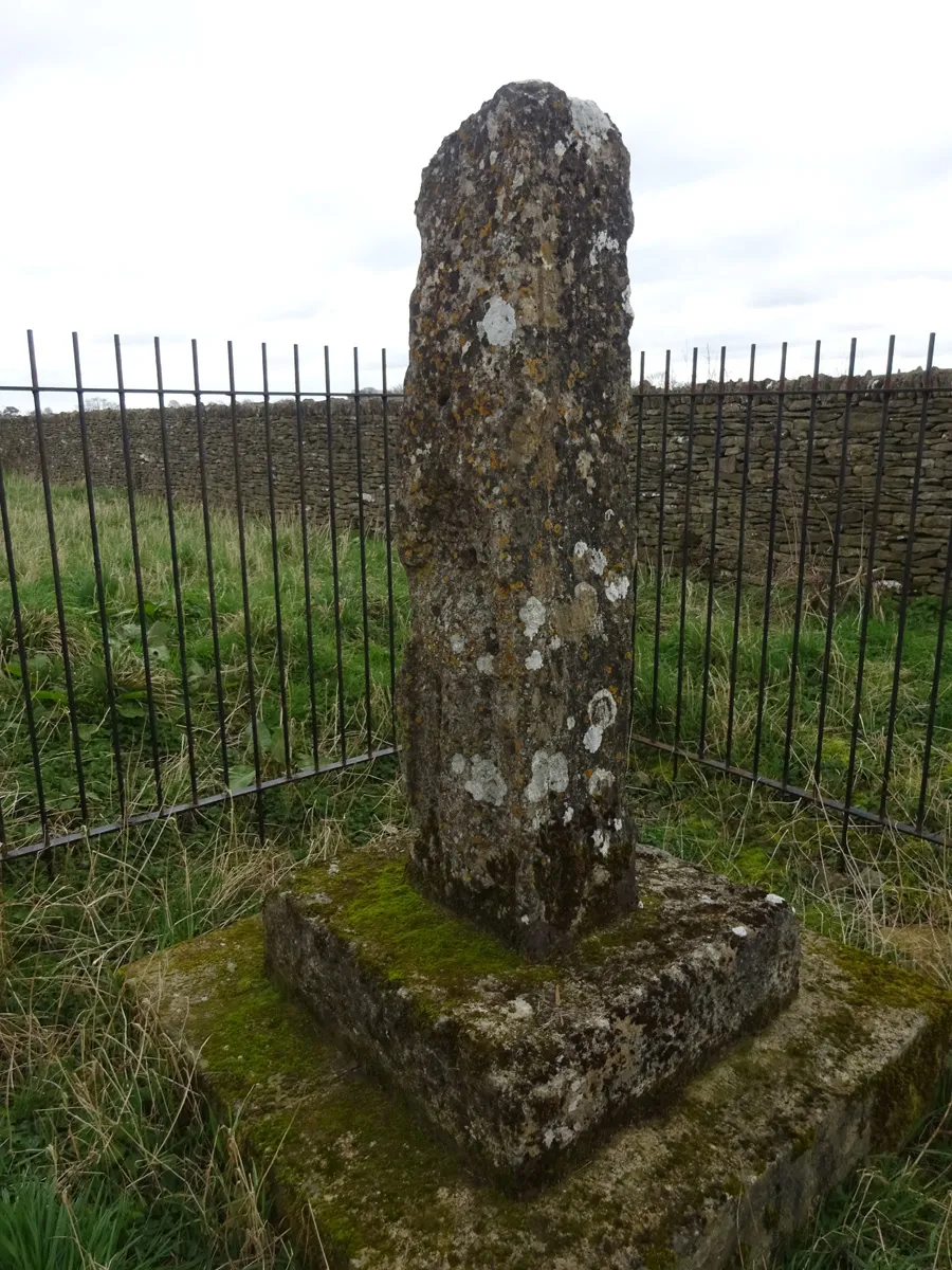 Photo showing: base and shaft of a Saxon Wayside Cross (minus the top) relocated to this location in Victorian times to serve as a Boundary Marker. Formerly on the corner of Stancombe Lane.