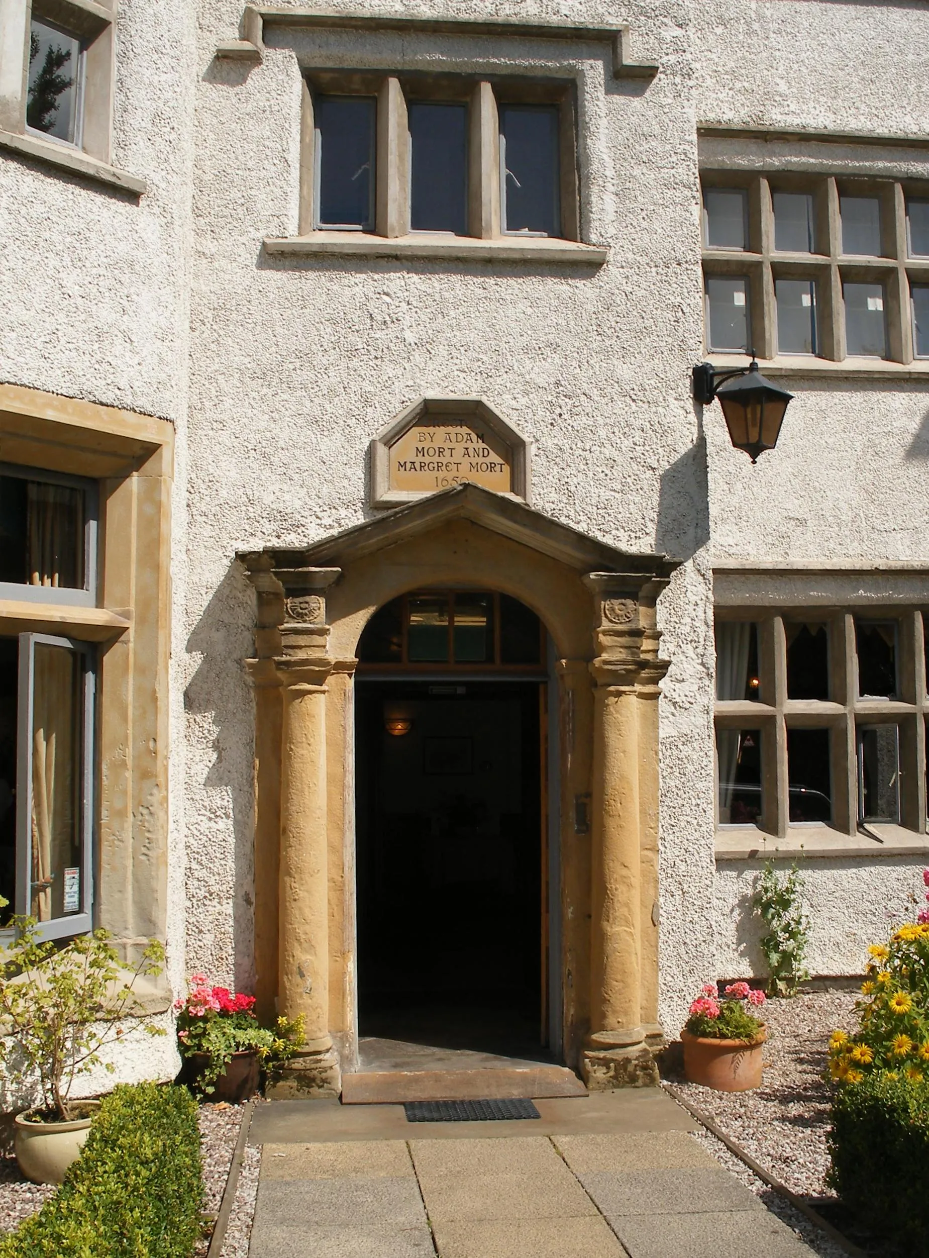 Photo showing: This is the doorway of Dam House Astley. The inscription over the lintel reads, "Erected by Adam Mort and Margret Mort 1650"