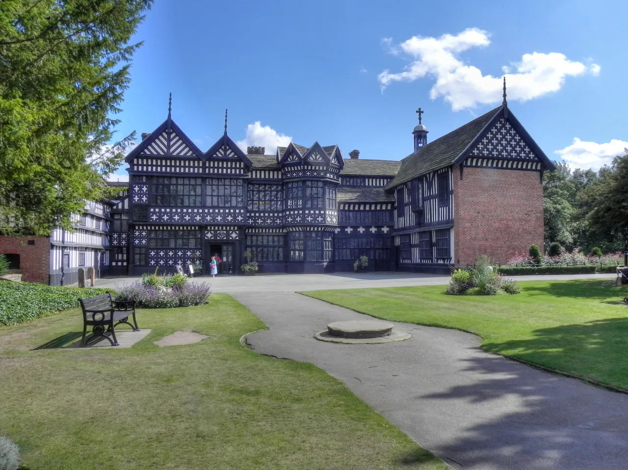 Photo showing: Bramall Hall viewed from the west, showing the main entrance, the courtyard and the north and south wings. The Great Hall is in the centre.