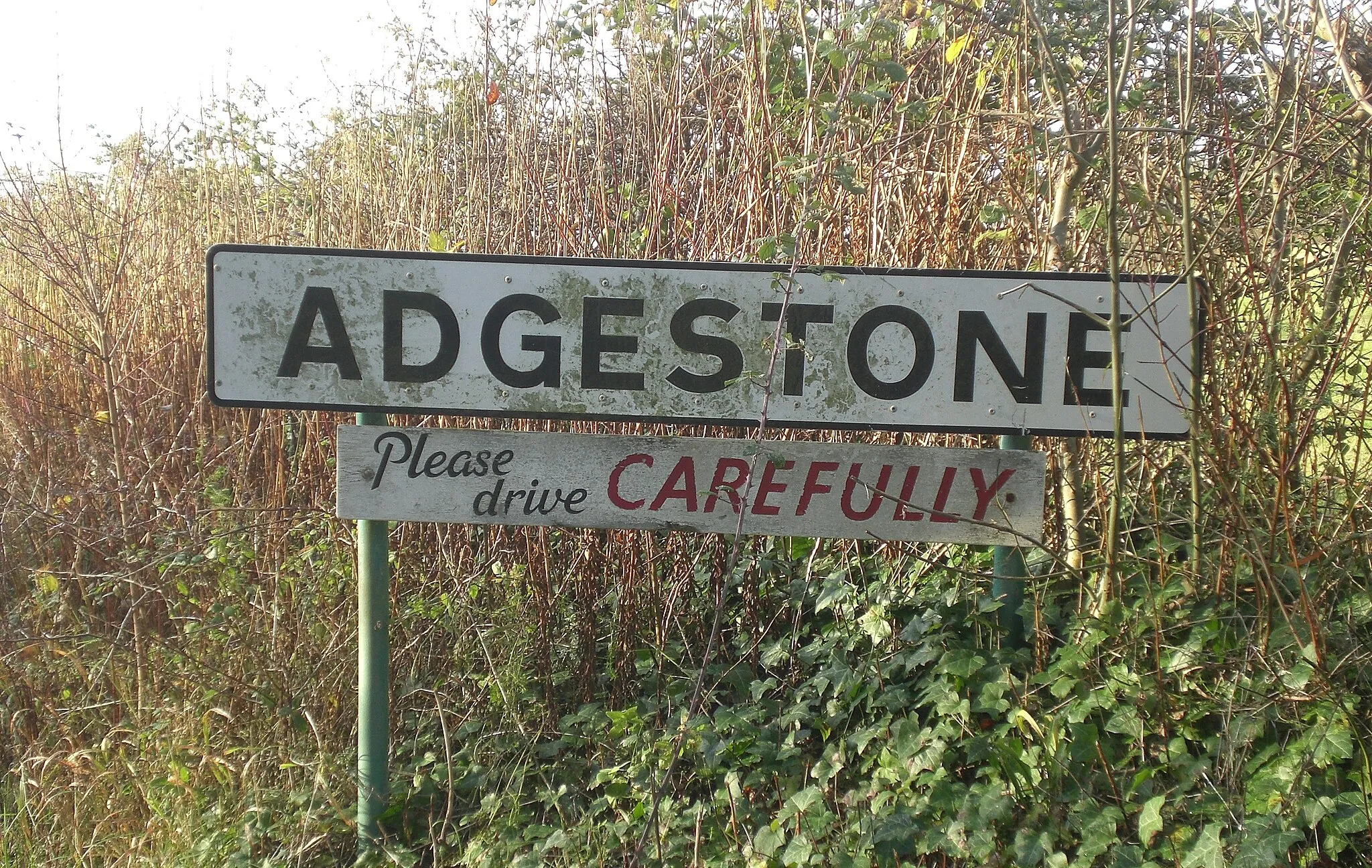 Photo showing: The sign entering Adgestone on the Isle of Wight leading into the village. The words "Please Drive Carefully" appear underneath.