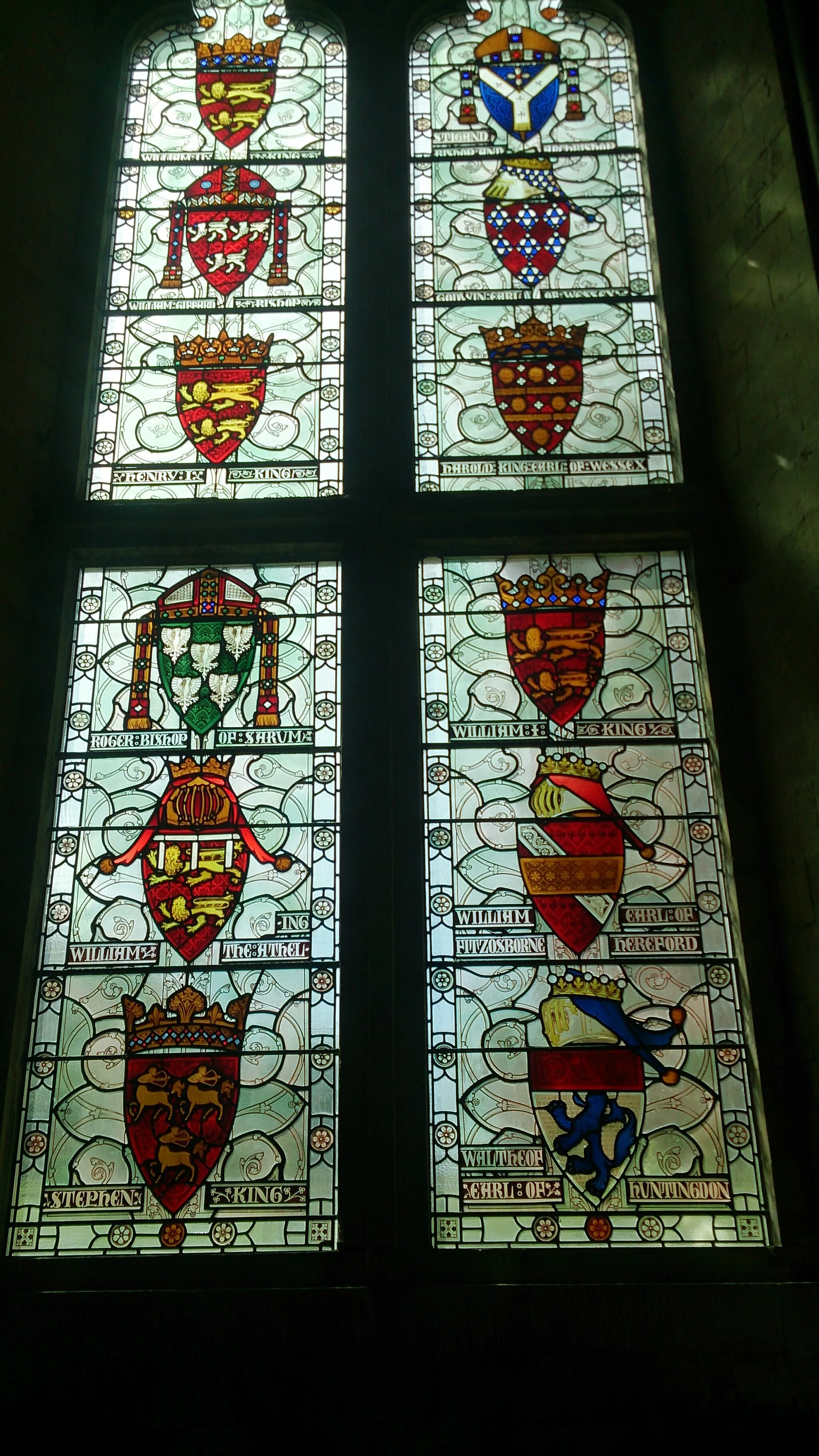 Photo showing: The 2nd window in Winchester Great Hall, representing
William II of England: Gules two leopards Or
Stigand: Azure a stole argent per pall with crosses sable fringed Or over a cross flory argent pierced gules on a staff Or
William Giffard: Gules three lions passant argent langued azure
Godwin, Earl of Wessex: Lozengy gules and vair
Henry I of England: Gules two leopards Or
Harold Godwinson: Gules two bars Or between 10 crosses floretty (4-3-3) argent and 6 bear's heads afronty Or
Roger of Salisbury: Vert five eagles argent
William the Conqueror: Gules two leopards Or
William Adelin: Gules two leopards Or, labelled argent
William FitzOsbern, 1st Earl of Hereford: Gules a bend argent, overall a bar Or
Stephen, King of England: Gules three centaurs regardant Or with bows nooked of the same
Waltheof, Earl of Huntingdon and Northumbria: Argent a lion azure, with a chief gules
