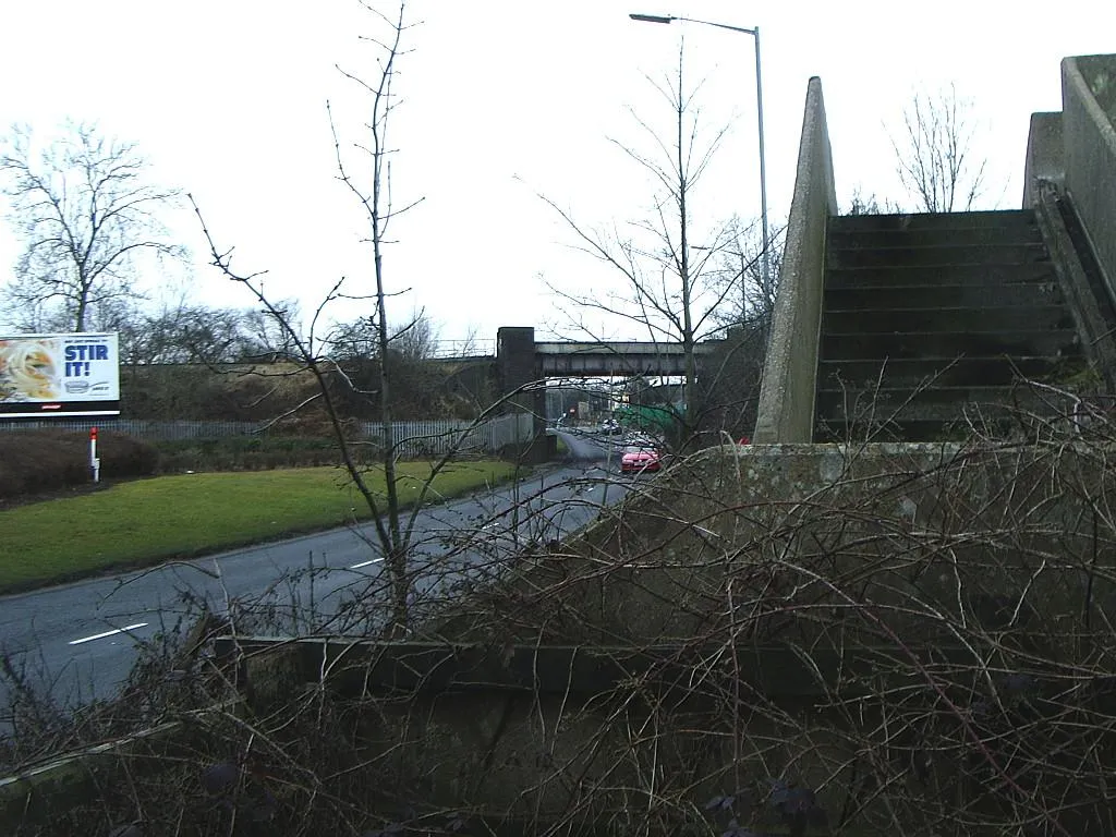 Photo showing: A38 Kingsbury Road, Minworth Footsteps up onto Taylors bridge, crossing Birmingham and Fazeley Canal.  Freight line railway bridge crossing A38 Kingsbury Road.  
Beyond the bridge is Castle Vale housing estate.  Off to the left this side of bridge is Midpoint Business Park.