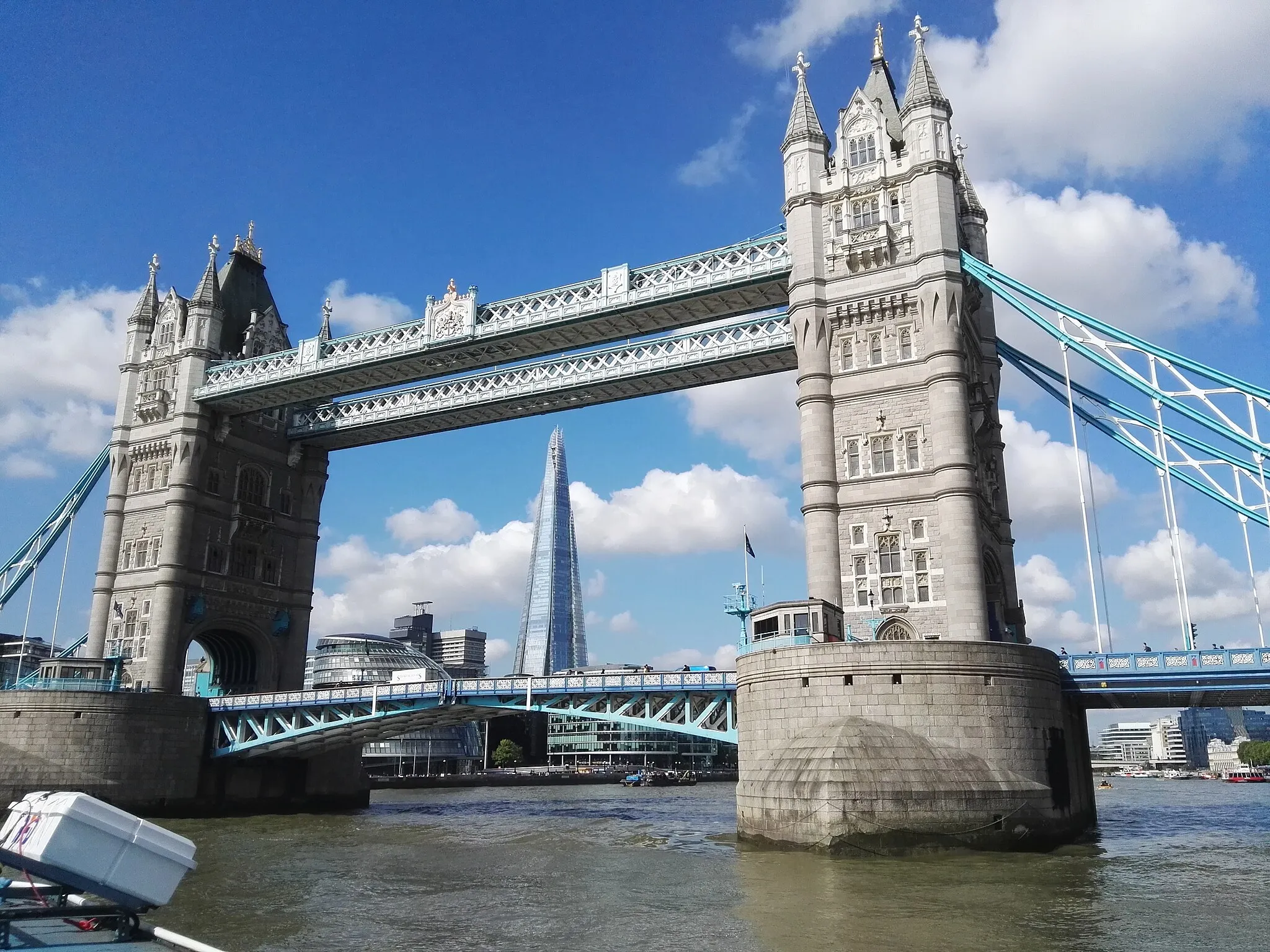 Photo showing: Tower Bridge with a view of The Shard photographed from a boat on the River Thames