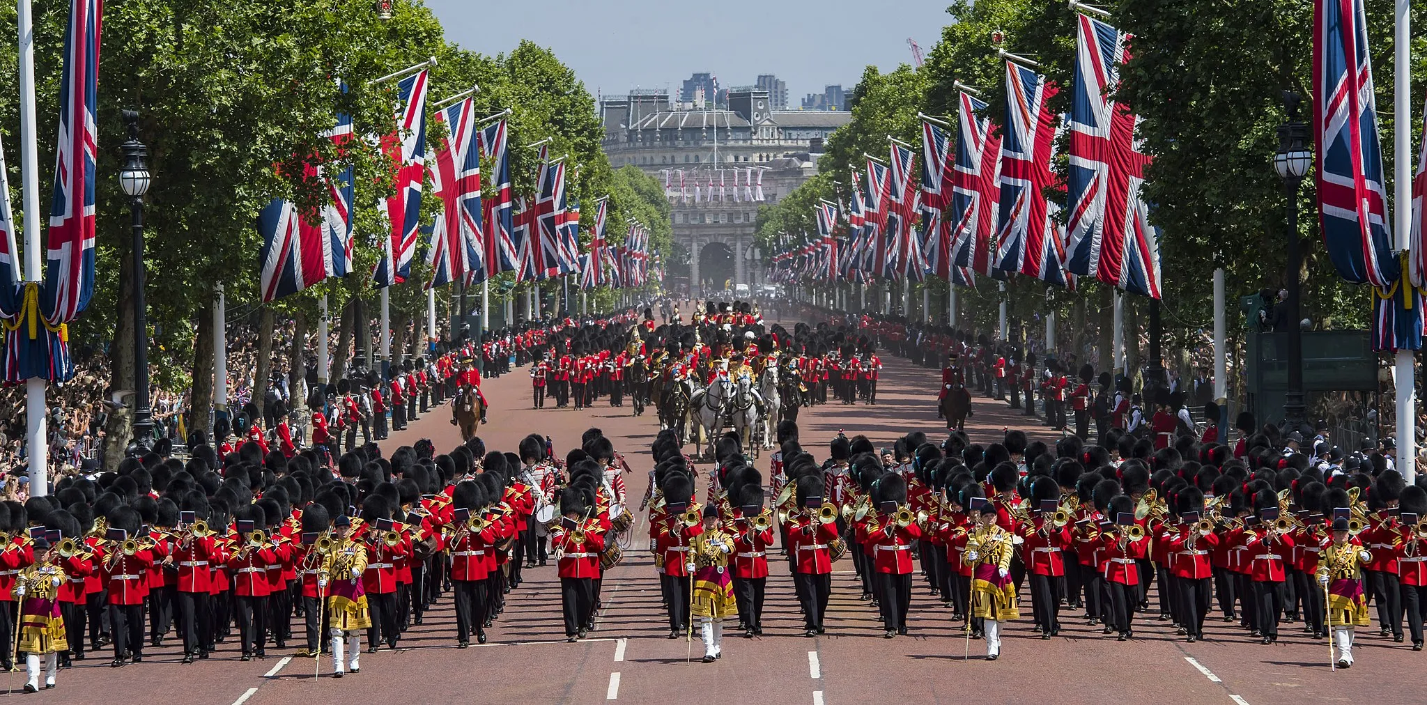 Photo showing: Pictured are Soldiers of the Mass Bands and Household division marching in front of and behind HM Queen Elizabeth returning back to Buckingham Palace.
All the Royal Colonels accompanied Her Majesty on the parade, with The Prince of Wales, The Duke of Cambridge and The Princess Royal riding on horseback; The Duke of York also rode for the first time in his new capacity as the Colonel of the Grenadier Guards.
These operational soldiers, for many of whom this was their first Queen’s Birthday Parade, are fresh from recent exercises in Dartmoor.  They are famed across the world for their immaculate turnout and ceremonial prowess, but as a dual-role battalion they are equally busy with operational training and duties.

Organization: MOD
Object Name: APOLOND-2018-104-Queens Birthday Parade-SH -00101
Supplemental Categories: Ceremonial, Army
Keywords: Royalty, Army, London, British Army, Whitehall, Band, Buckingham Palace, Cavalry, Bearskins, Coldstream Guards, Grenadier Guards, Guards, Household Cavalry Mounted Regiment, Kings Troop Royal Horse Artillery, Military Music, Queens Birthday Parade, Westminster, The Mall, Union Flag, Divisions and Brigades, HQ London District, The Household Cavalry, The Household Cavalry Mounted Regiment, Regiments, The Household Cavalry Regiment, HCR, The Life Guards, The Blues and Royals, HCMRD, Bands, Household Cavalry, Location, Parade, Royal Air Force, RAF, Clothing, Ceremonial, Lanyard, Sash, White Gloves, Mace, Cape, Musicians Jockey Cap, Aiguillette, Musicians Pouch, Equipment, Bearskin, Household Division, Bearskin Plume, Hackle
Country: United Kingdom