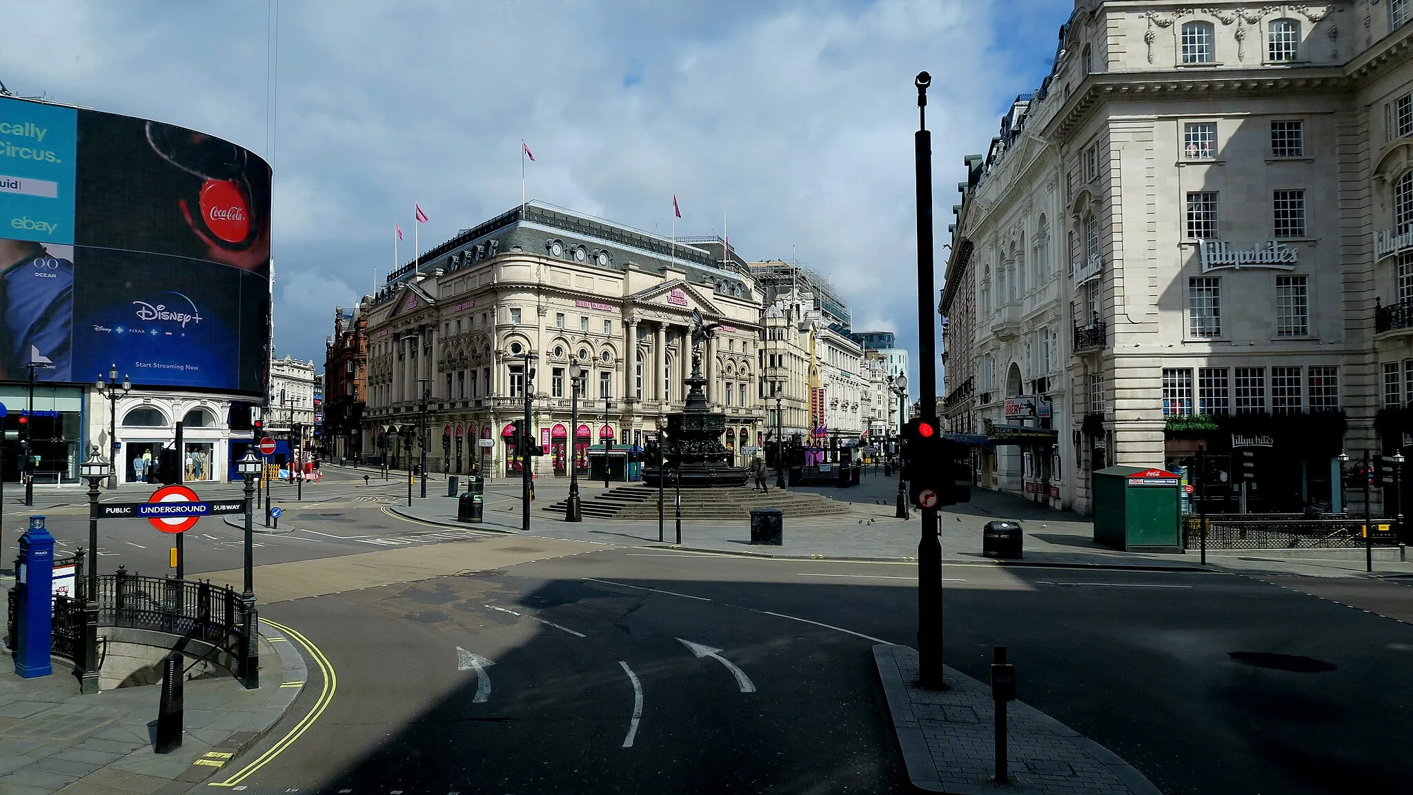 Photo showing: COVID-19 - Piccadilly Circus, London UK. No visitors on a bright spring day. Usually this would be packed with tourists.
