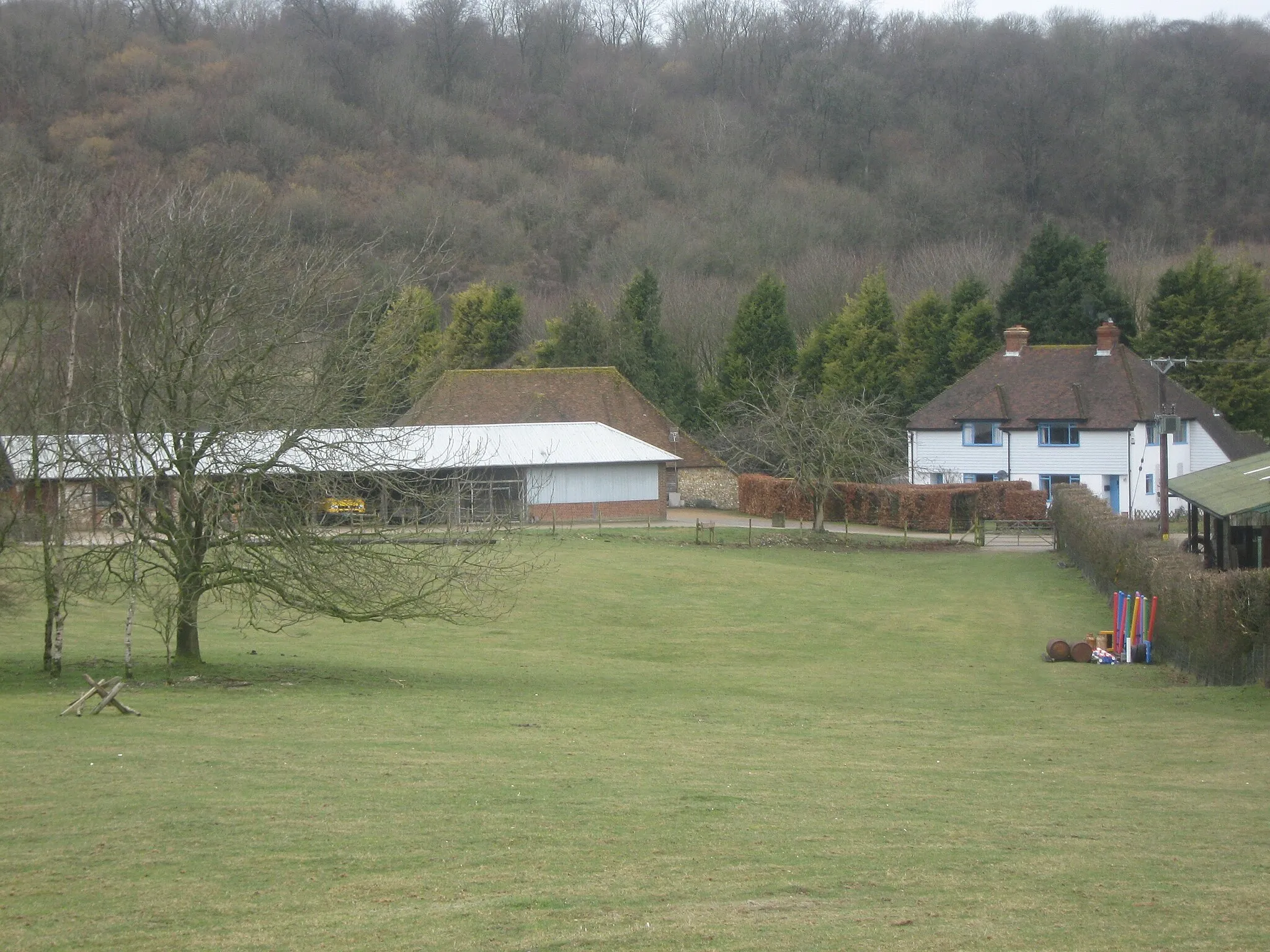 Photo showing: Big Coombe Cottages These two large cottages are near Coombe Manor. Collyerhill Wood is in the background.