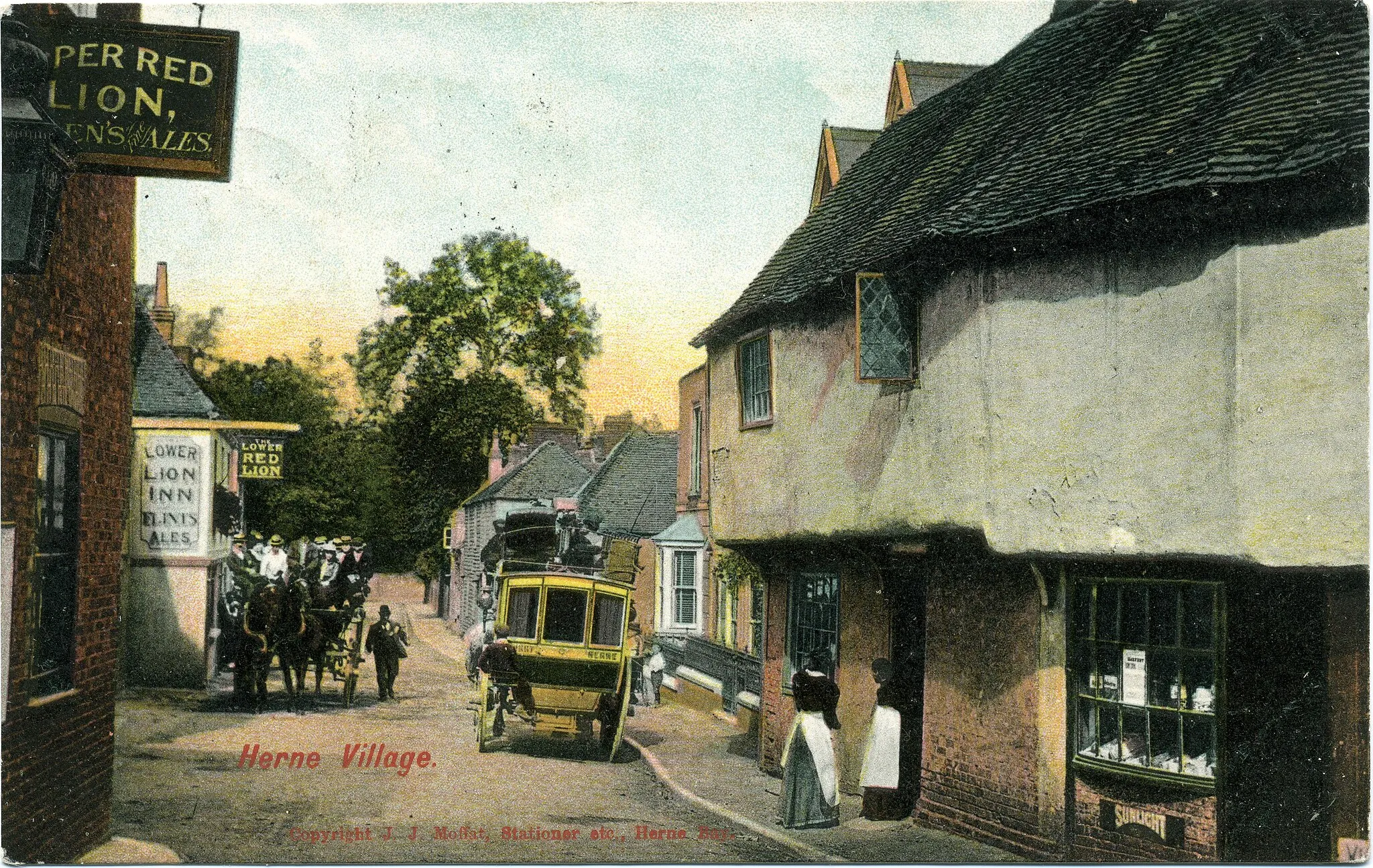 Photo showing: Postcard photo of the Canterbury-Herne Bay road as it passes through Herne, Kent, England. The postcard is postmarked 1905.  On the right is Smugglers Cottage.  The two pubs on the left are called Upper Red Lion and Lower Red Lion.

Points of interest
The group on the charabanc is possibly returning from a Sunday church or works outing to Herne Bay.
The liveried coach could be a mail coach.
The card is published by J.J. Moffat, stationer of Herne. Editing
This is an unedited scan of an historical photograph. If making adjustments to this image, please consider uploading your edit as a separate file.

Contrast
This print has darkened with age, but it would be inappropriate to adjust the brightness because detail would be lost.

Edges
The remaining borderless edges of this image are important for researchers of this type of vintage photograph. Some photographers trimmed their images more than others,and the border or edge is part of the artwork. Researchers need to see exactly where the edge of the postcard is. Thank you for taking the time to read this.