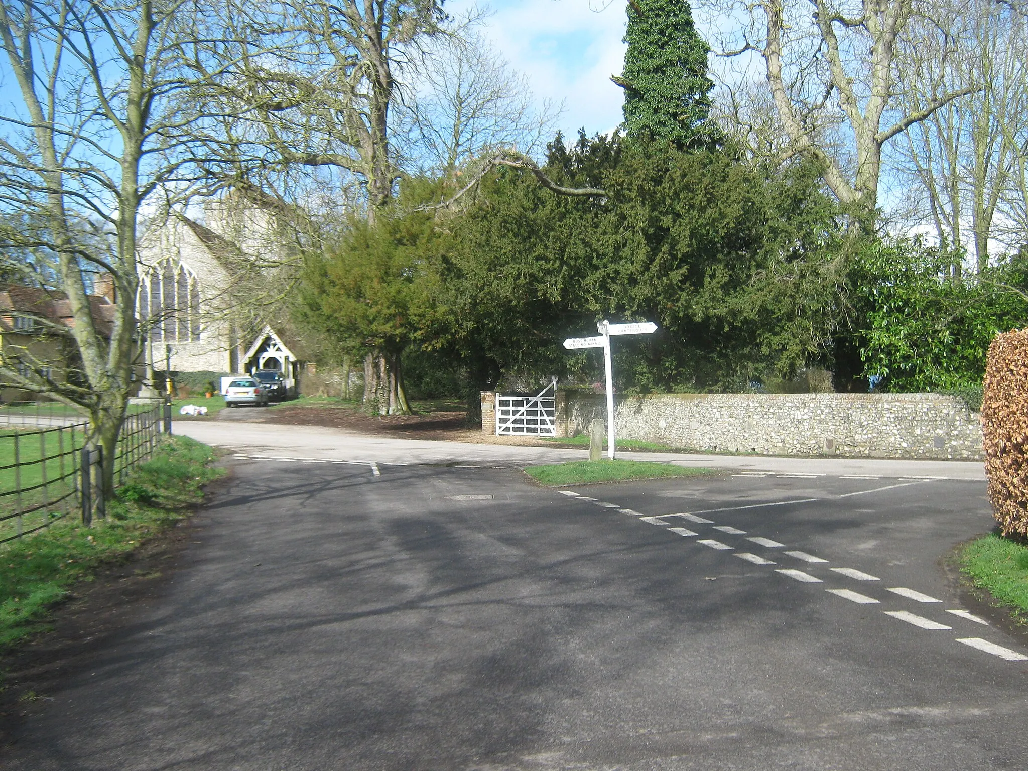 Photo showing: Road junction in Bishopsbourne The Street (from the village pub) meets Crows Camp Road heading left towards Langham Park Farm, and Frog Lane heading right towards the A2 Dual Carriageway Dover Road. St Mary's Church is in the background.