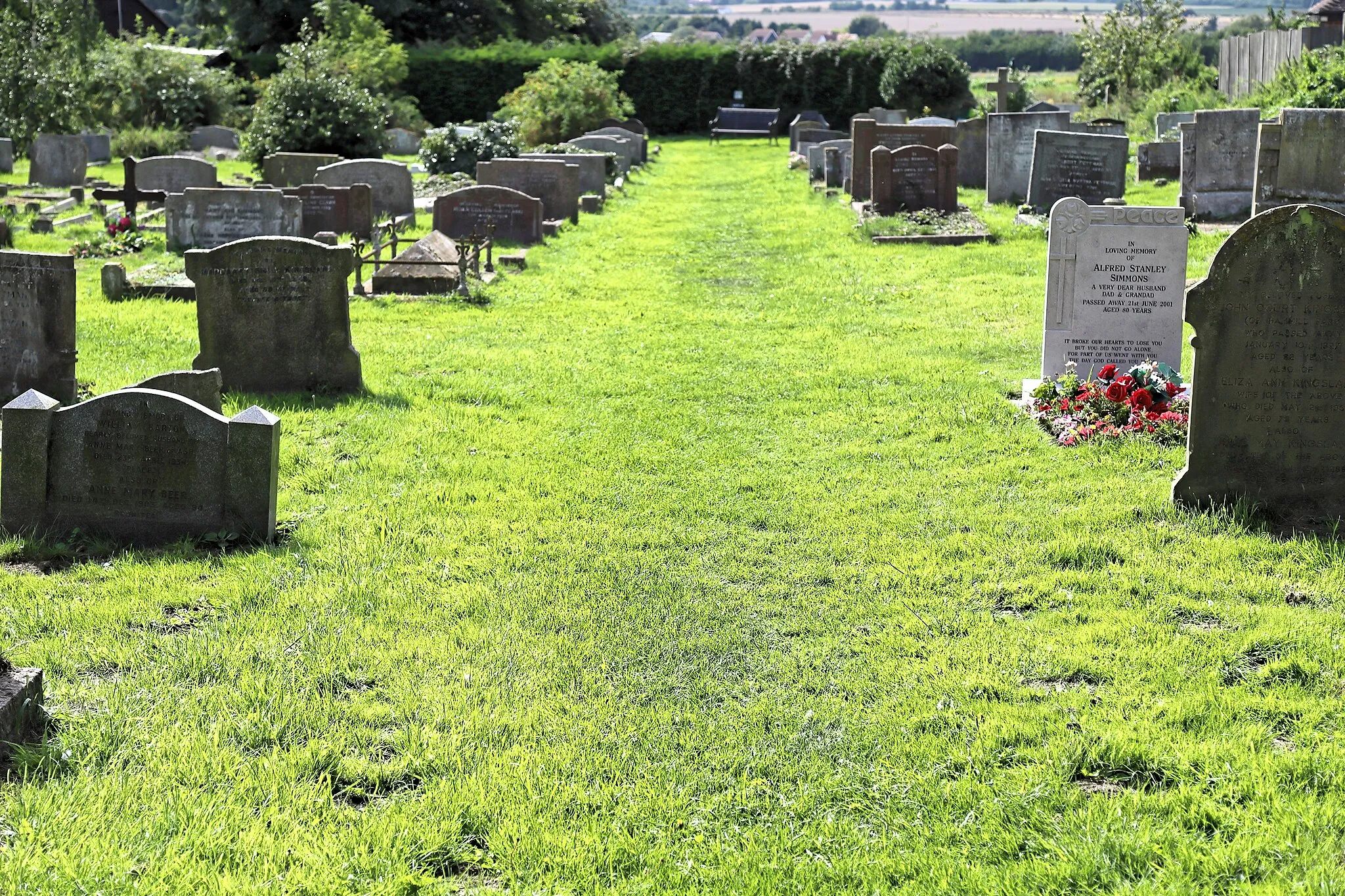 Photo showing: Grass pathway through the new parish graveyard beyond the west of the Grade II* listed St Mary the Virgin's Church in Woodnesborough, Kent, England. Camera: Canon EOS 6D Mark II with Canon EF 24-105mm F4L IS USM lens. Software: File lens-corrected, optimized, perhaps cropped, with DxO OpticsPro 11 Elite, and likely further optimized with Adobe Photoshop CS2.