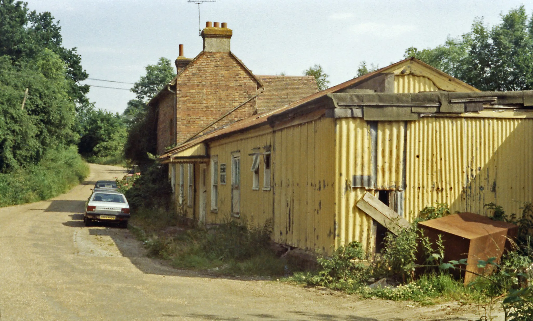 Photo showing: Cranbrook station (remains), 1984,
View SE, towards Hawkhurst (probably on the trackbed, with uninspiring station buildings on the right): ex-SE&CR Paddock Wood - Hawkhust branch, closed 12/6/61. The station was actually at Hartley, about two miles from Cranbrook!