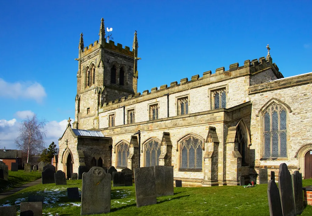 Photo showing: (St Mary)The large churchyard of this prosperous village contains a very fine collection of Swithland slate headstones (the great majority of which face east,so best seen before noon).