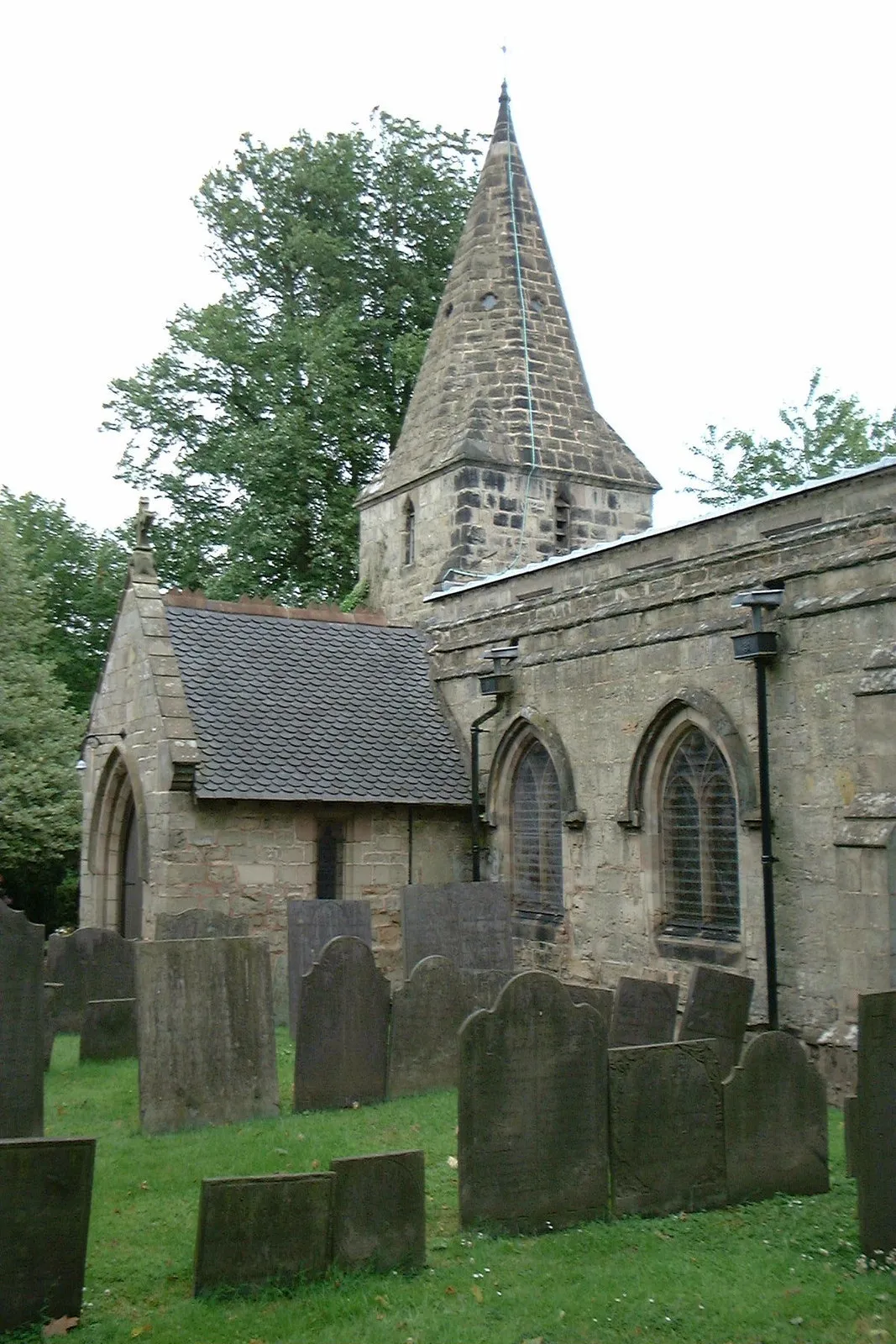 Photo showing: Spire and south porch of St Michael and All Angels parish church, Ravenstone, Leicestershire, seen from the east