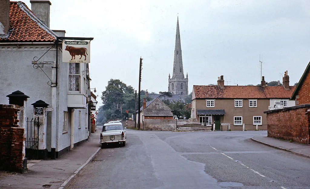 Photo showing: Bottesford: the Bull Inn and church.
View looking north in Market Street, with my car outside the pub.