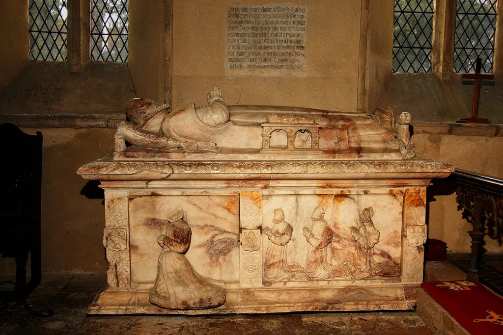 Photo showing: St Denys' parish church, Stonton Wyville, Leicestershire: alabaster chest tomb of Edmund Brudenell, died 1590. Alongside the father, a swaddled baby lies on its own tomb. (There is a similar arrangement at Exton, Rutland.)