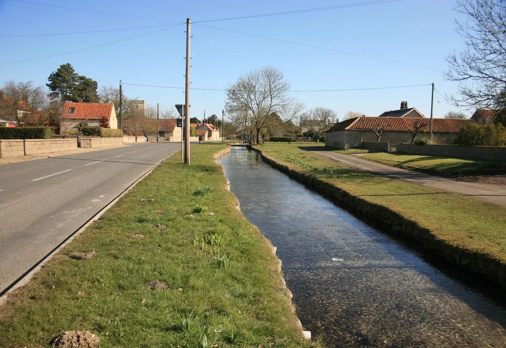 Photo showing: Scopwick village approach on the B1191 .The stream runs alongside the road here for some distance. The church tower can be seen on the skyline.