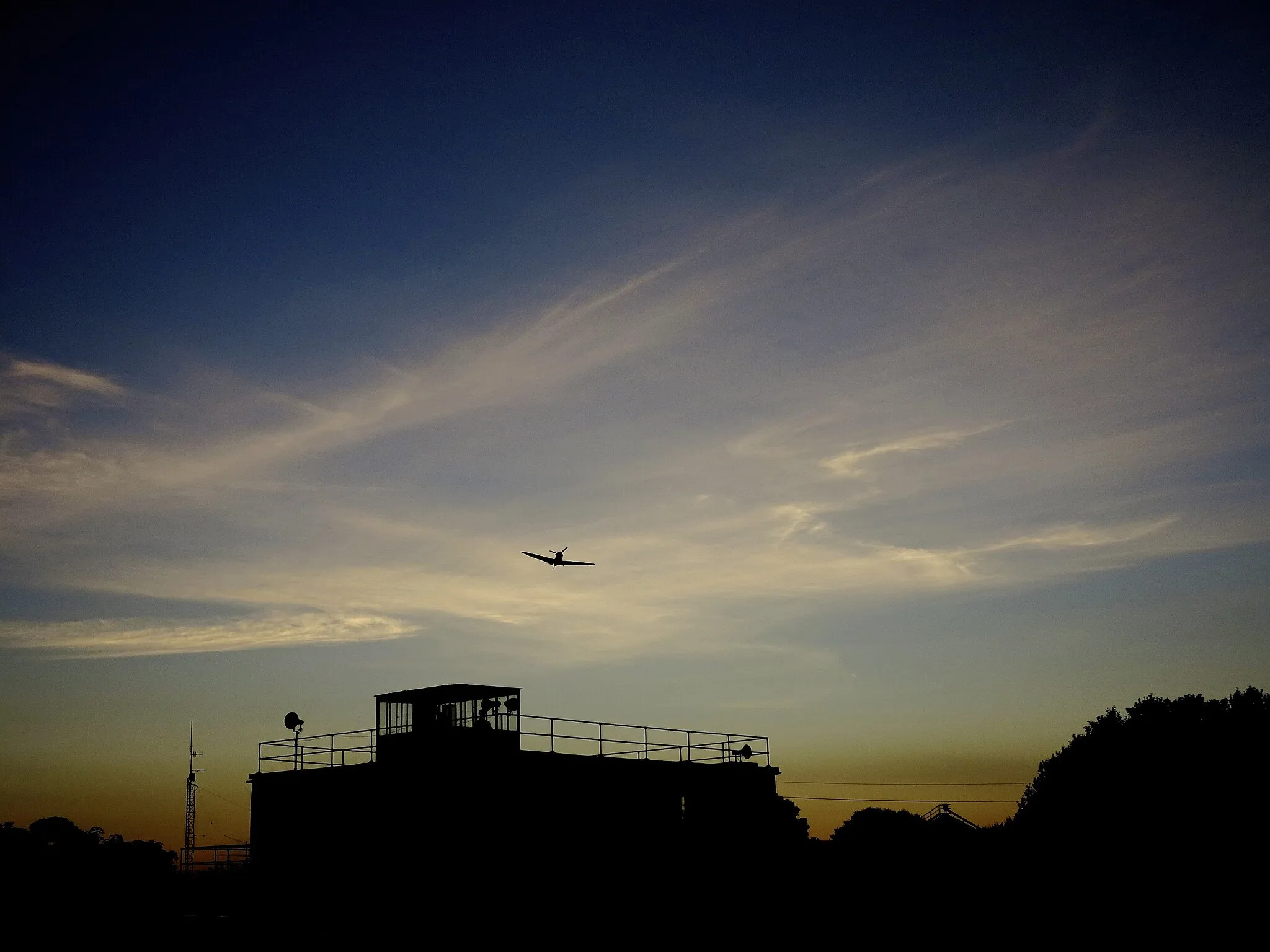 Photo showing: A Memorial Flight Spitfire approaching the Lincolnshire Aviation Heritage Centre Control Tower