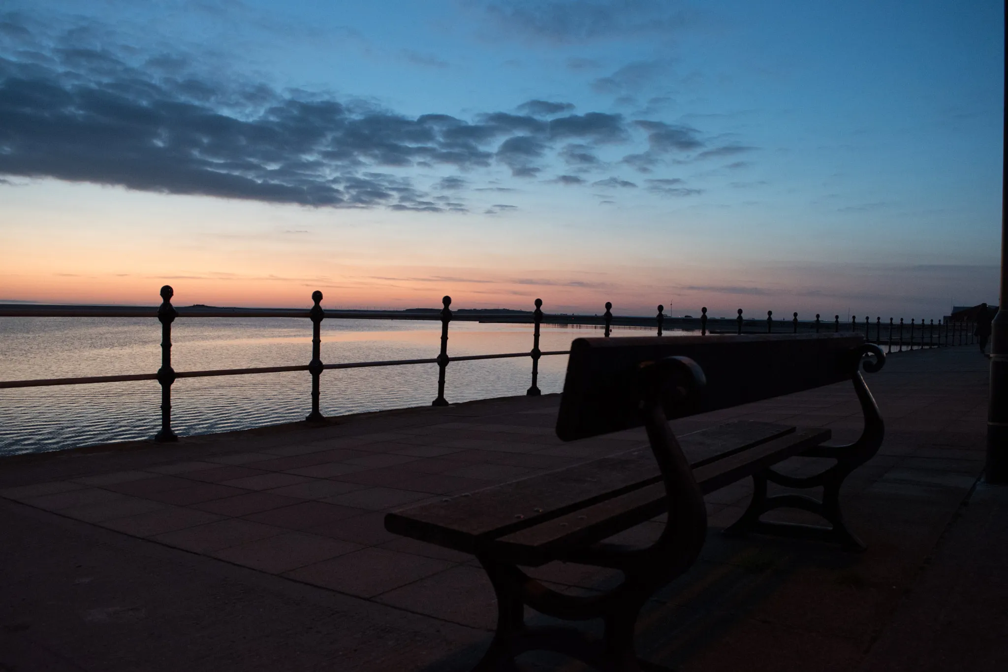 Photo showing: 500px provided description: Bench facing West Kirkby Marina looking out over the water, shortly after sunset. [#Landscape ,#England ,#UK ,#Water ,#Street ,#Bench ,#Sky ,#Sunset ,#Clouds ,#River ,#Merseyside ,#Wirral ,#Railings ,#Promenade ,#River Dee ,#River Mersey ,#West Kirkby Marina ,#West Kirkby]