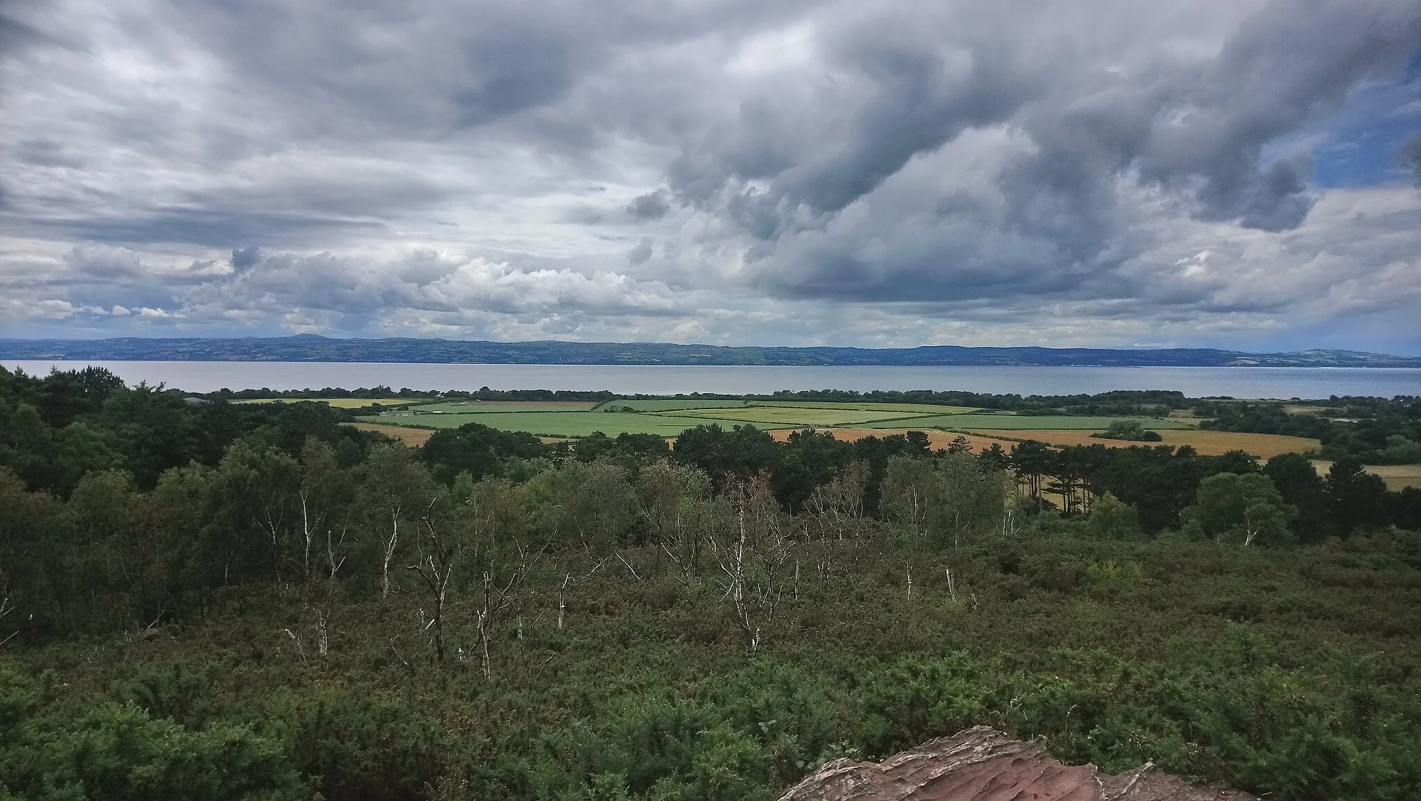 Photo showing: The view looking out towards Wales and the River Dee from the top of Thurstaston Hill on the Wirral peninsula.