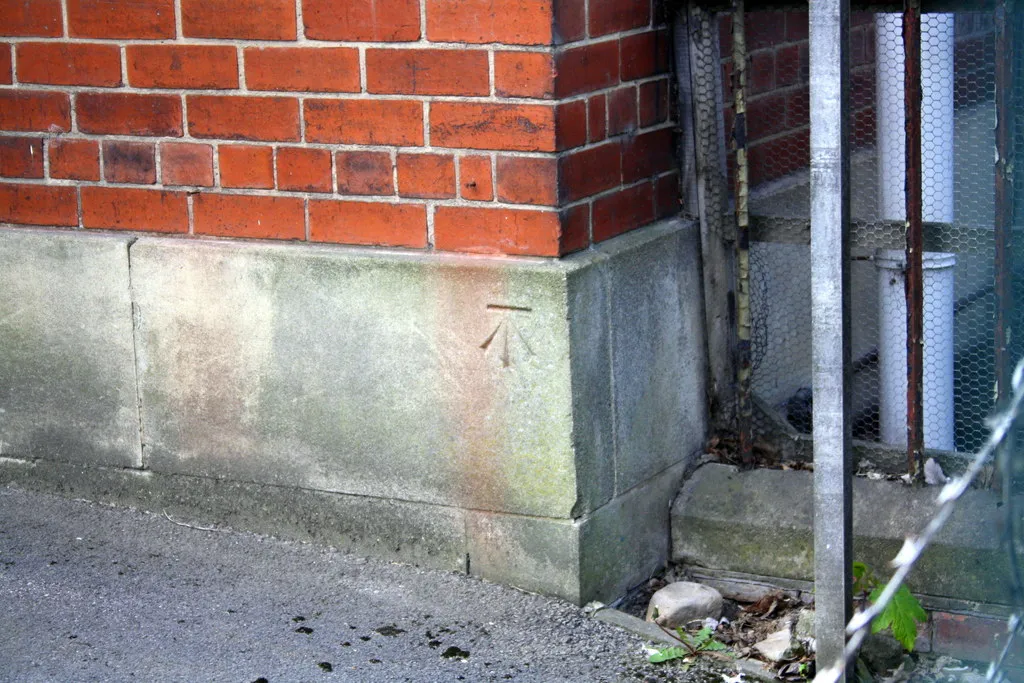 Photo showing: Benchmark on Building 45